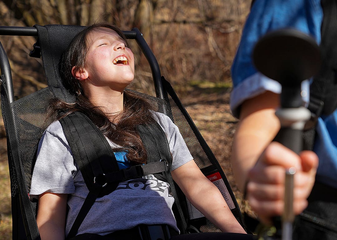 Luci Wilde reacts as she rides in a hiking cart designed by her dad, LJ Wilde.
