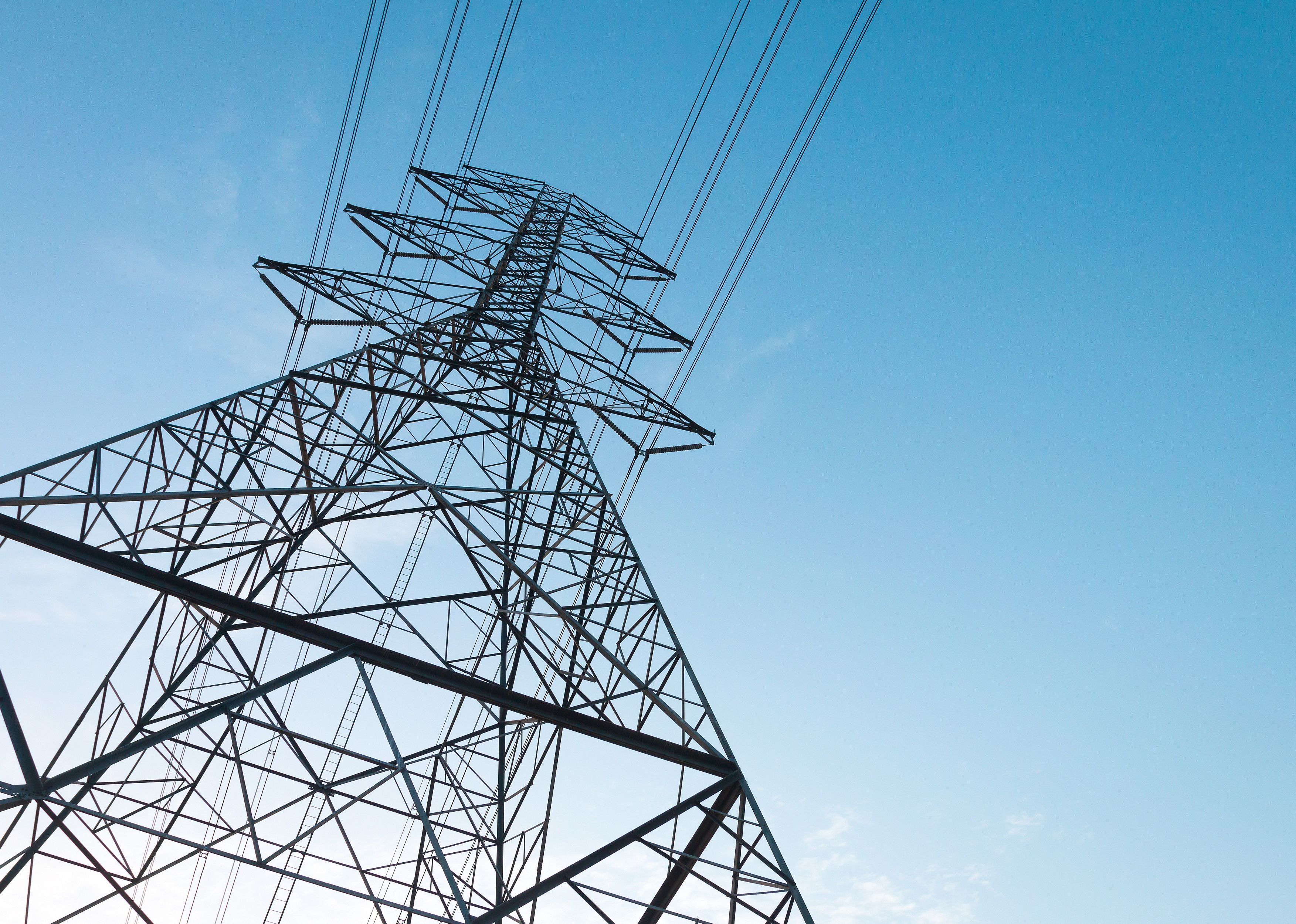 Electricity transmission power lines at sunset.