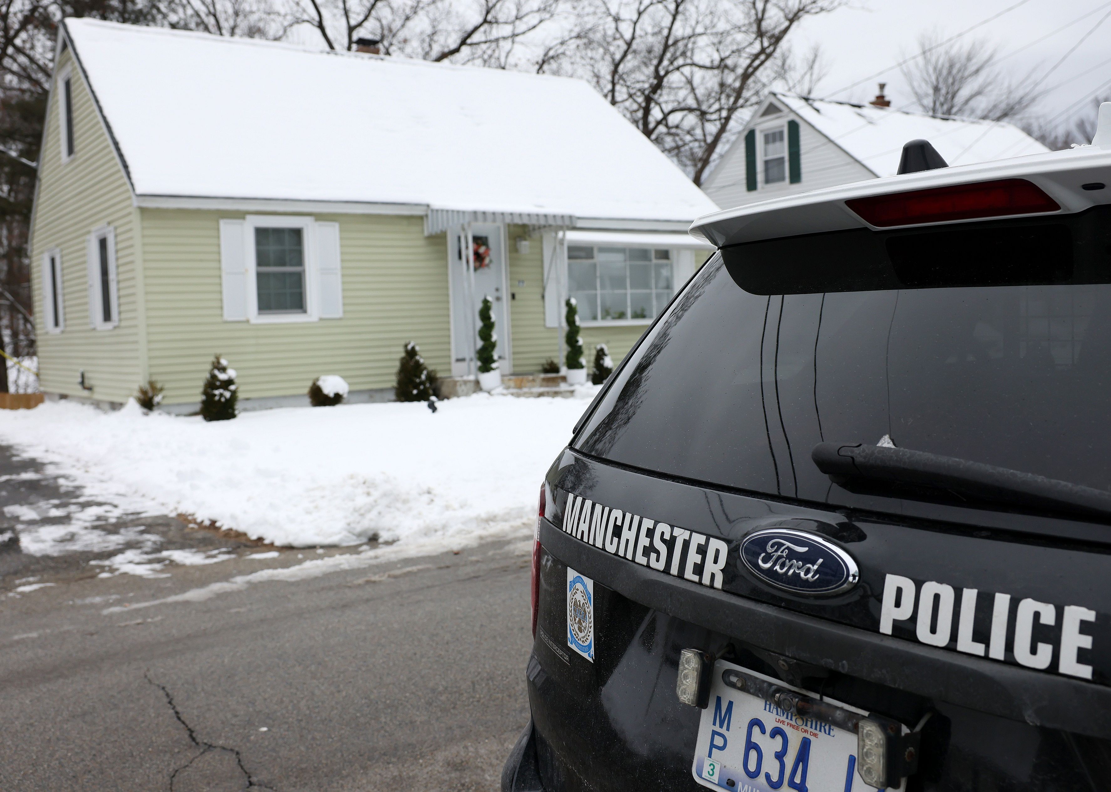 Manchester police car in front of a house.