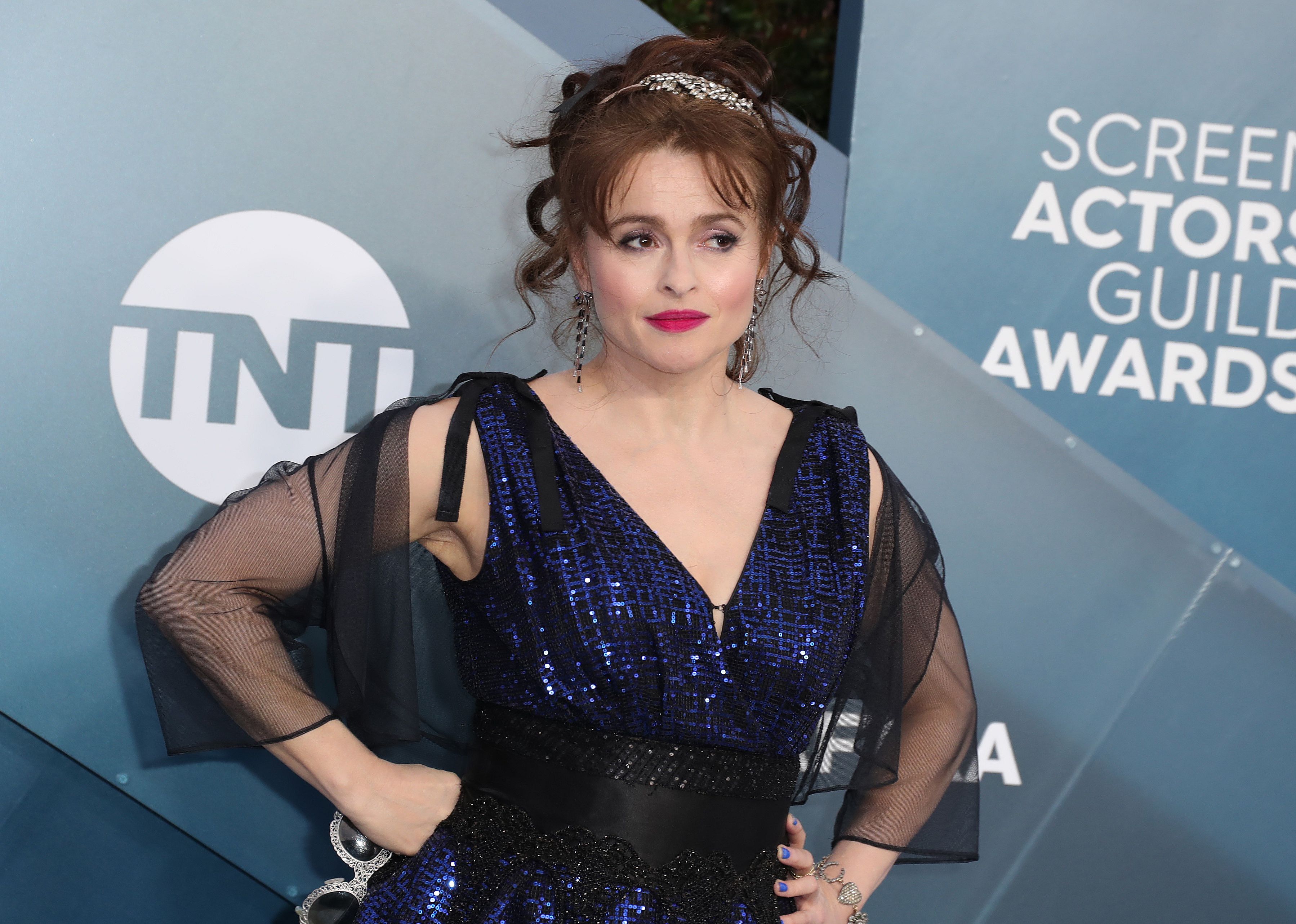 Helena Bonham Carter in a blue sequin dress with a black sheer wrap.