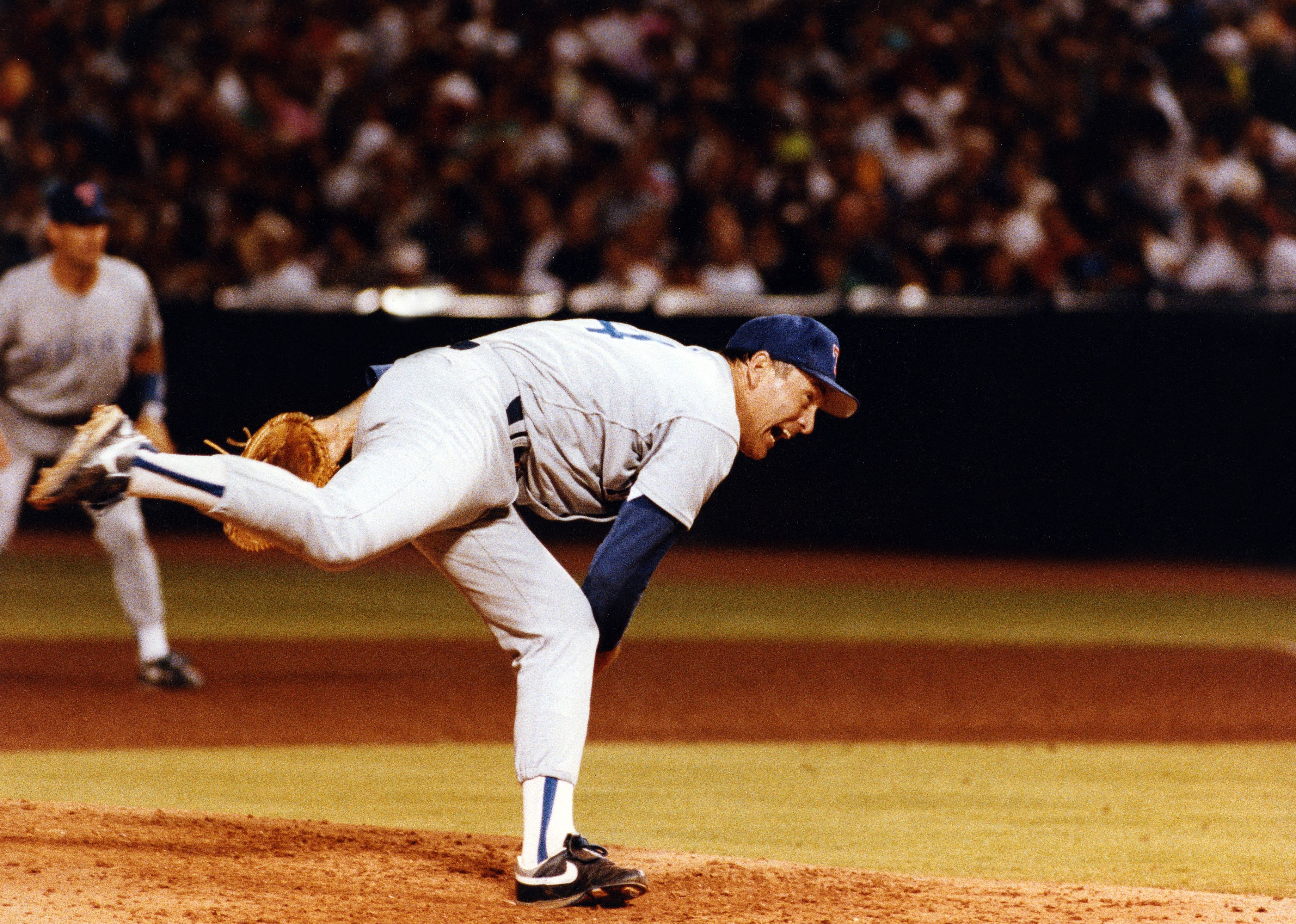 Nolan Ryan throws a pitch during a game