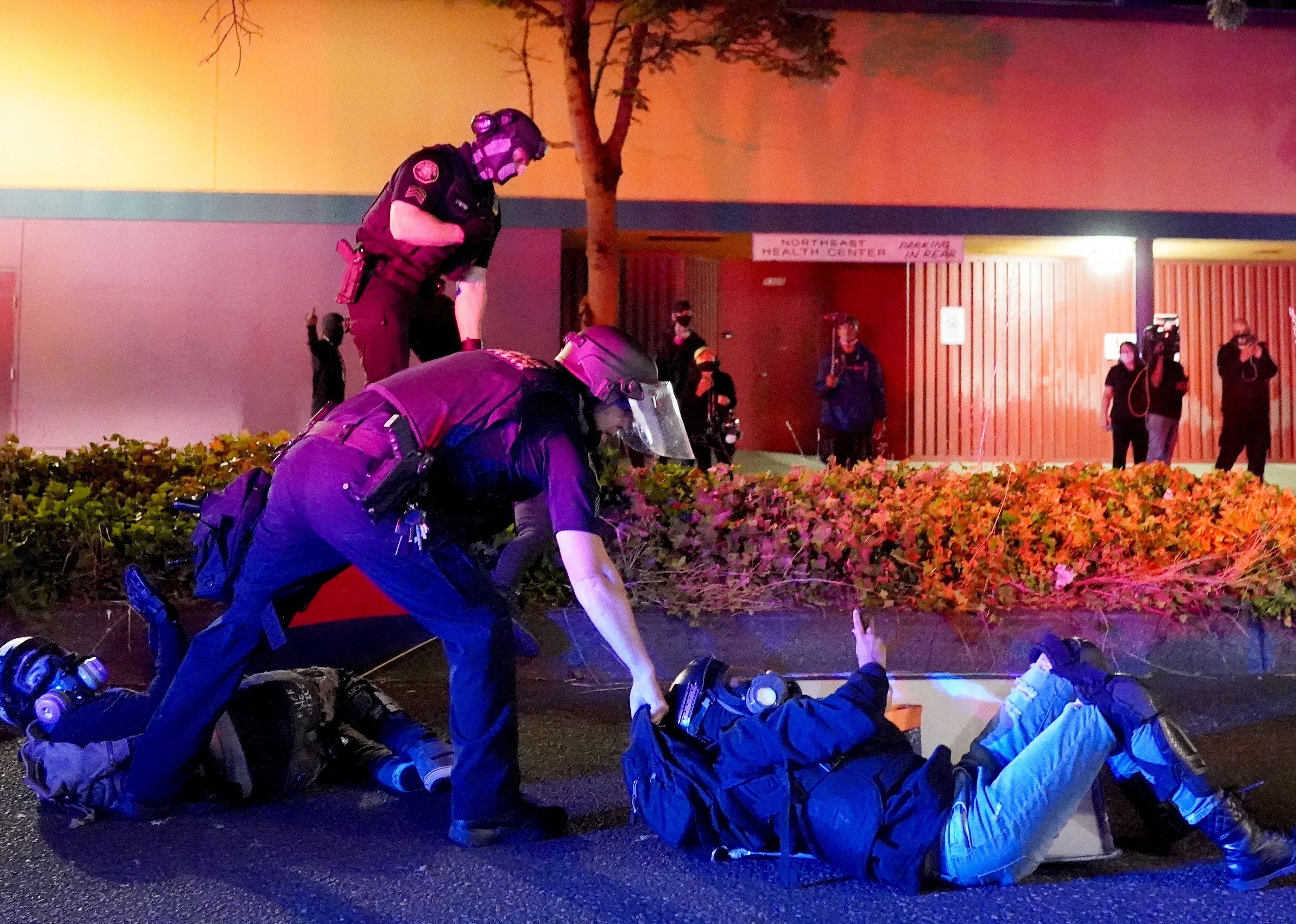 Portland police and Oregon State Patrol troopers arrest two protesters.