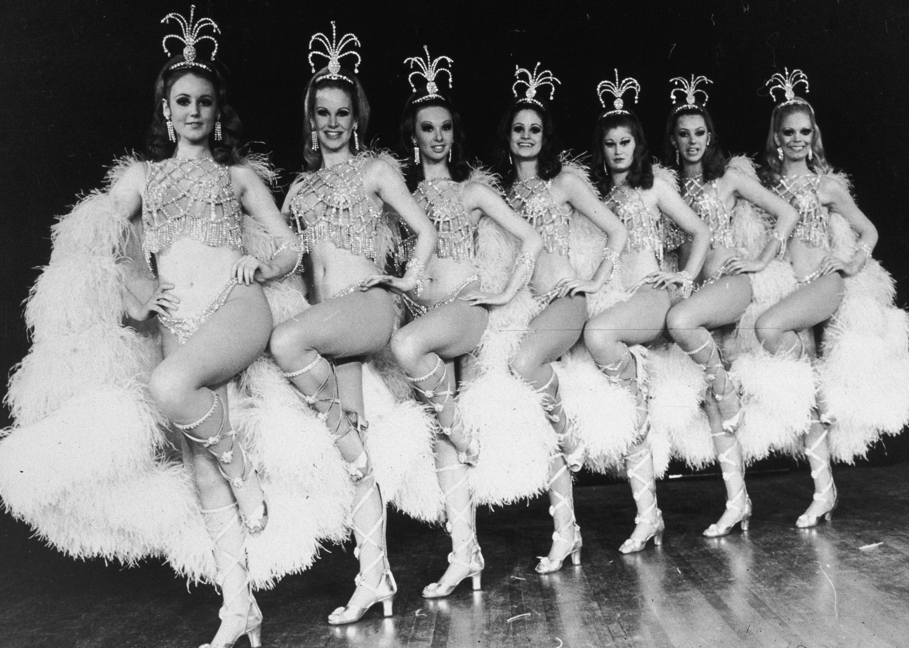 The Rockettes lined up in formation with elaborate costumes.