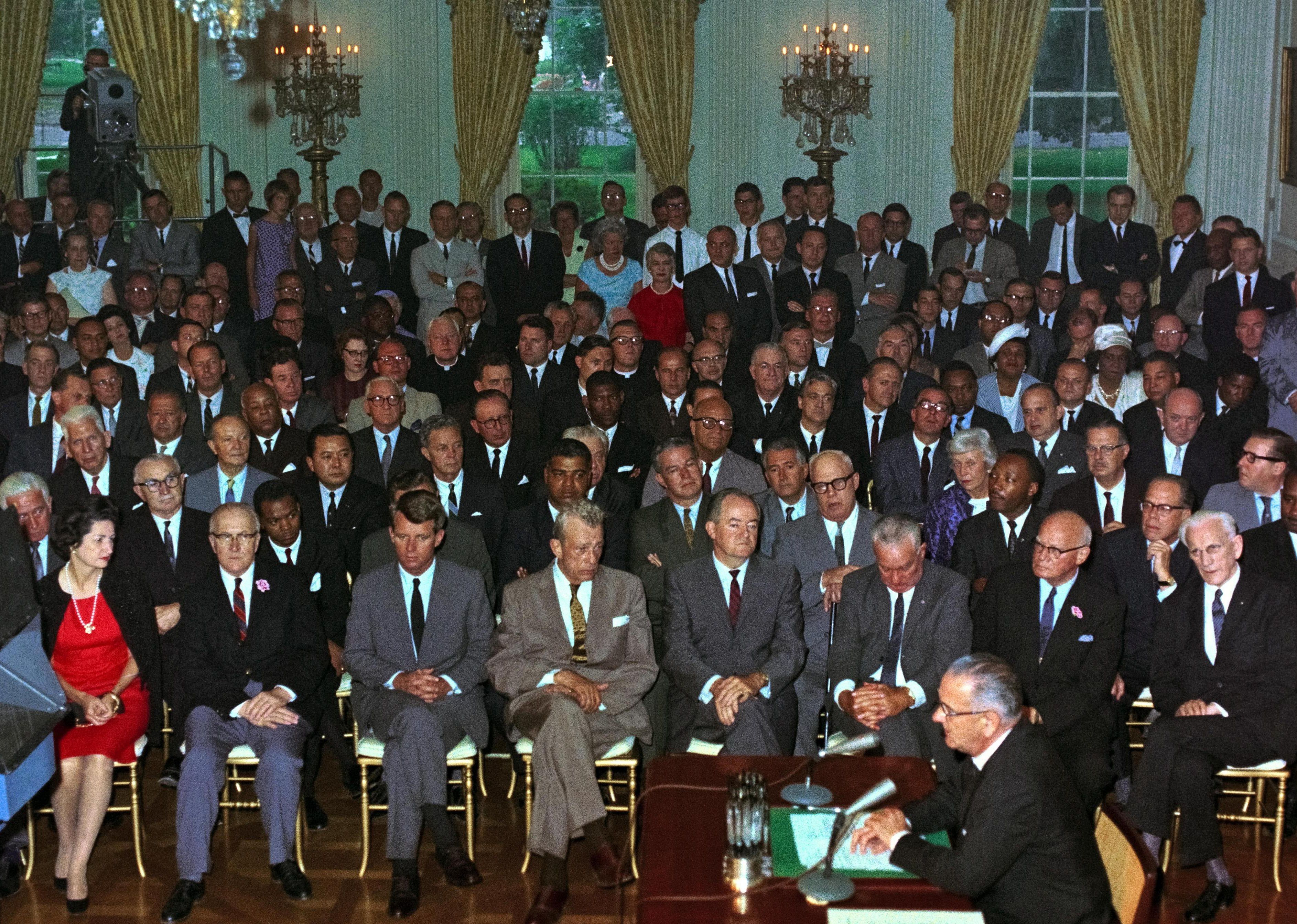 1964: President Johnson signs Civil Rights Act