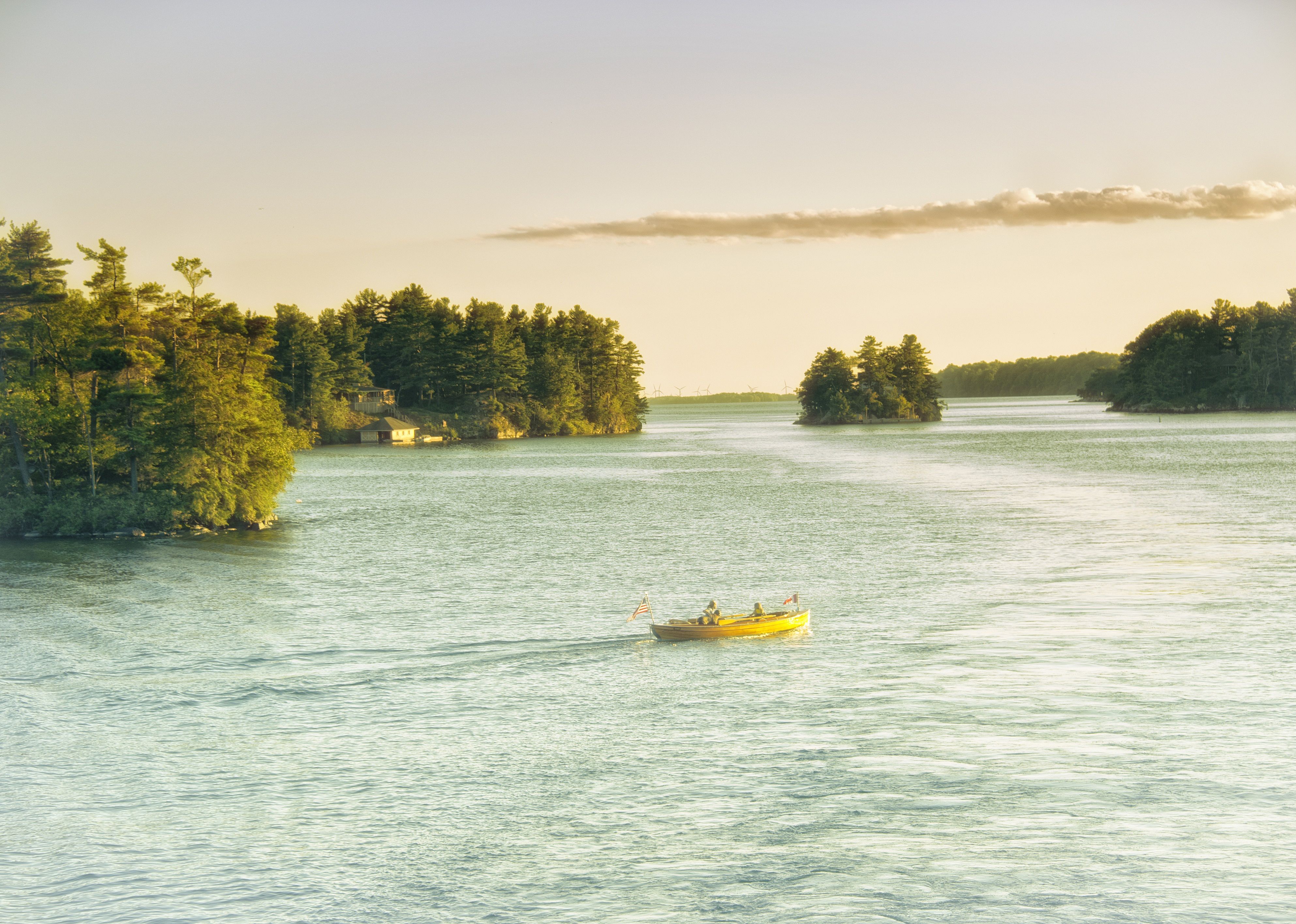 Sunset at Thousand Islands with boat in the water.