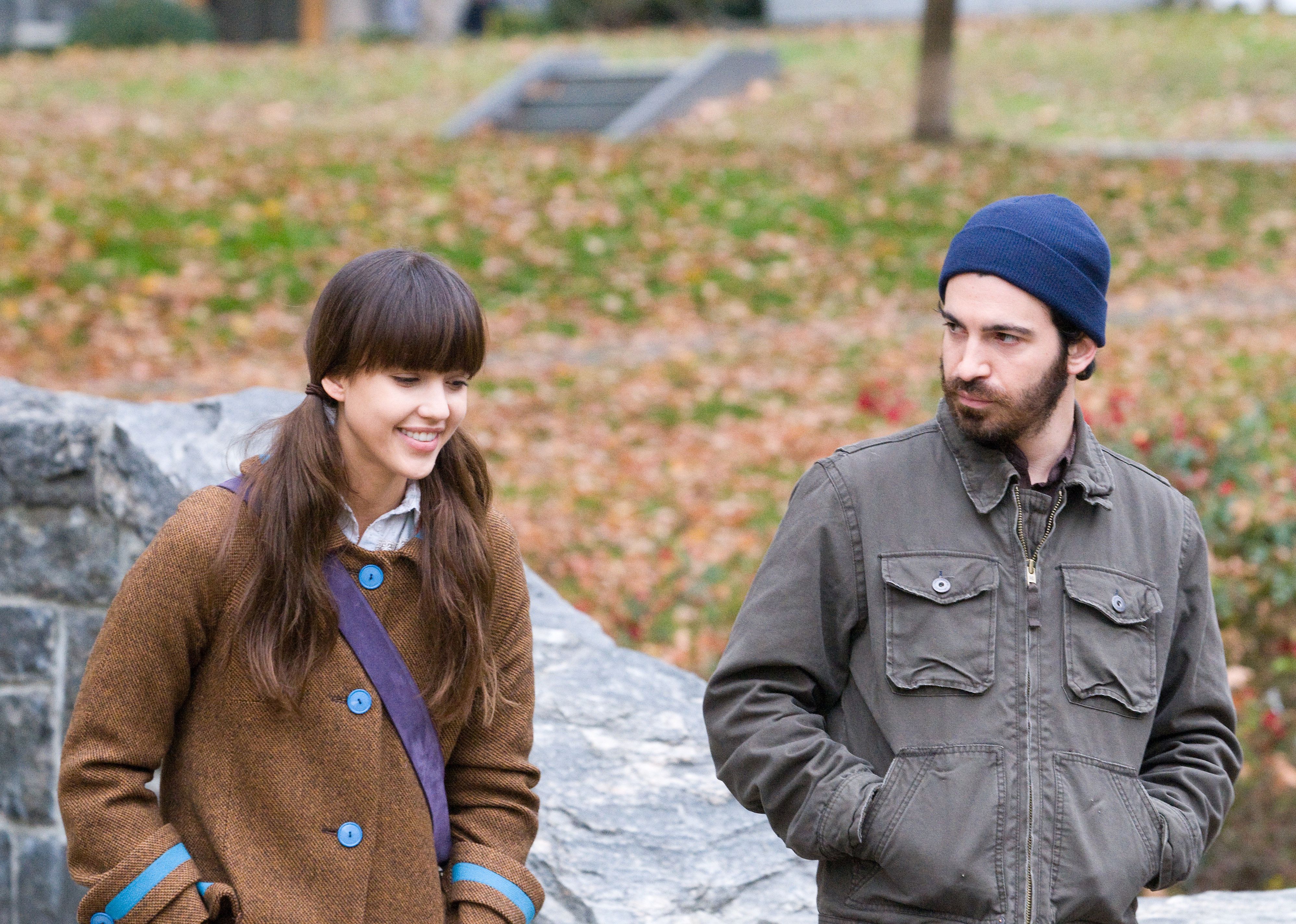 Jessica Alba with pigtails walking with Chris Messina in a park. 