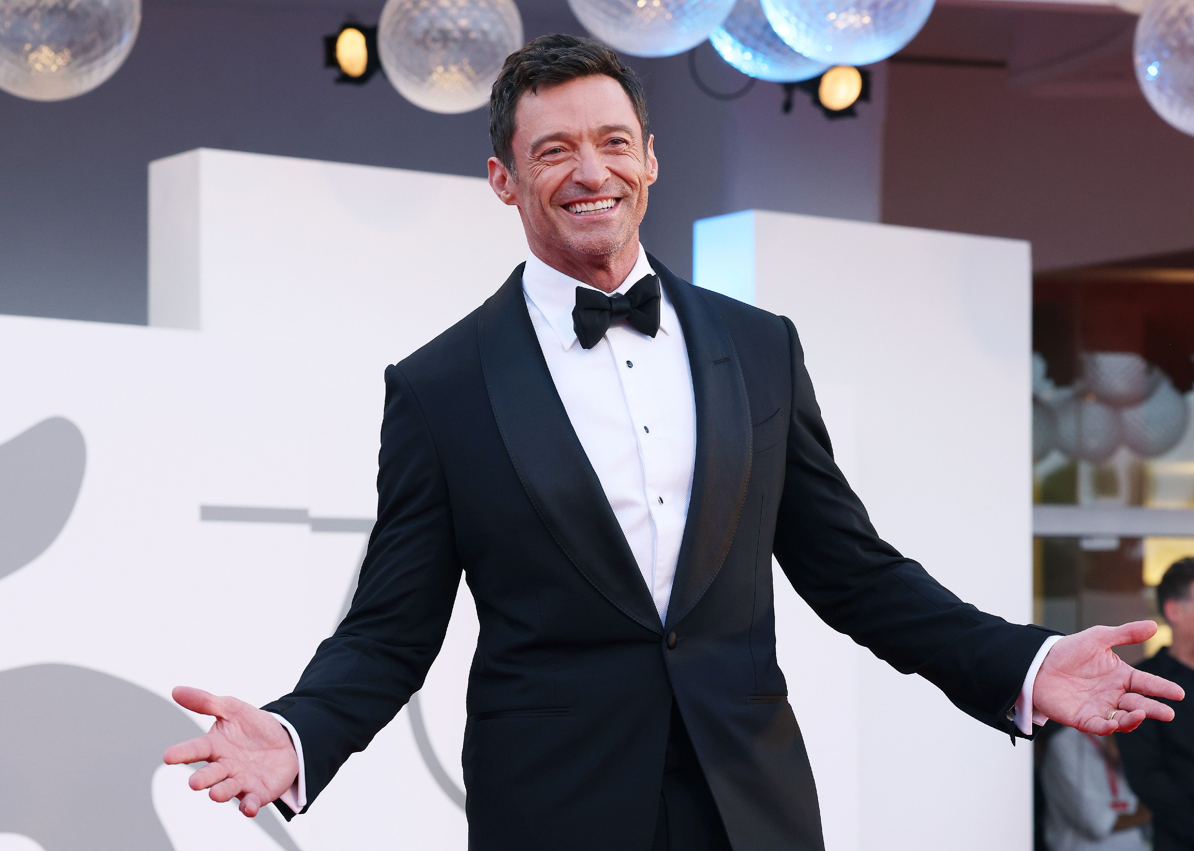 Hugh Jackman in a black suit and bowtie.