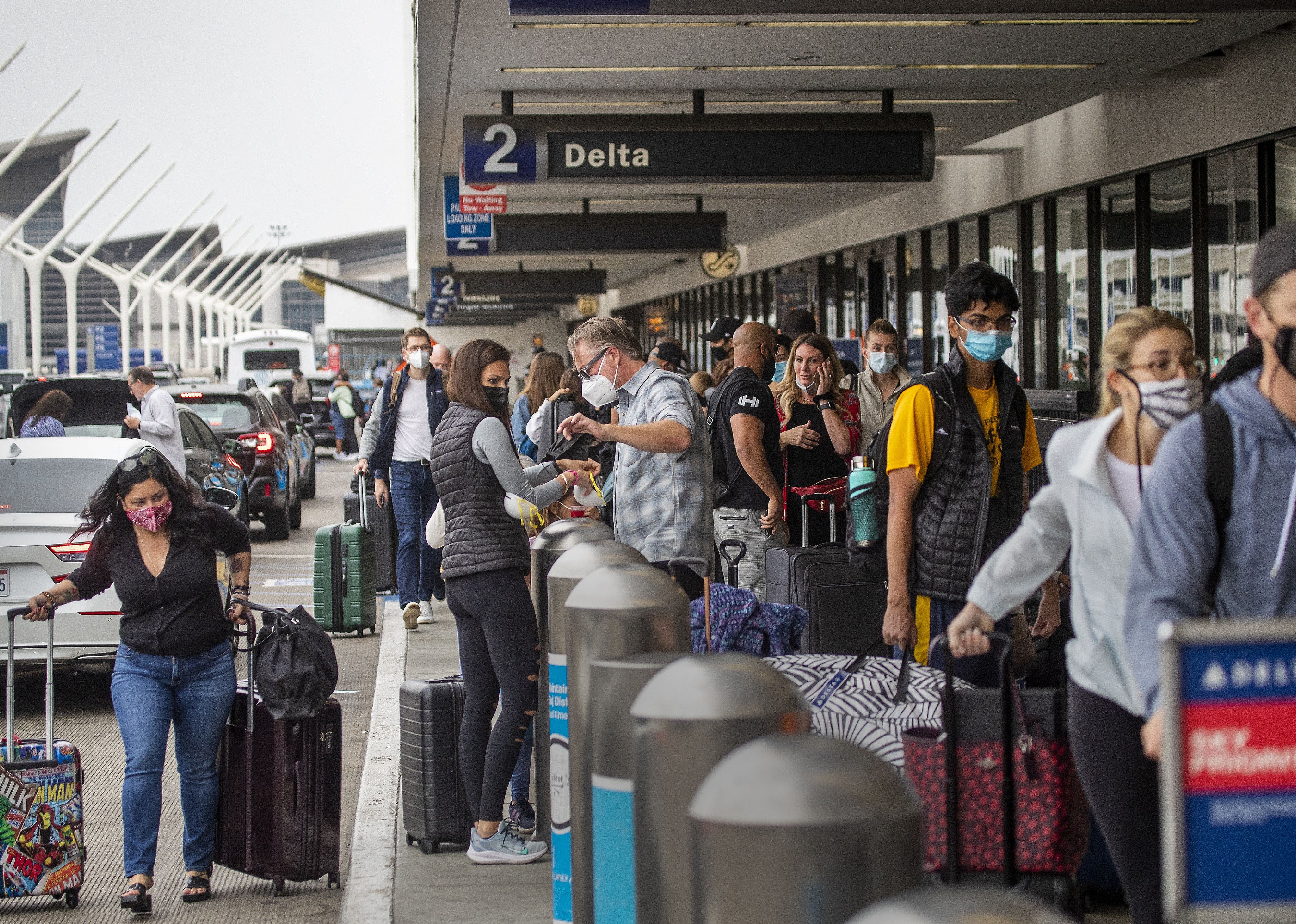 A crowded line at a Delta check-in outside at the airport.