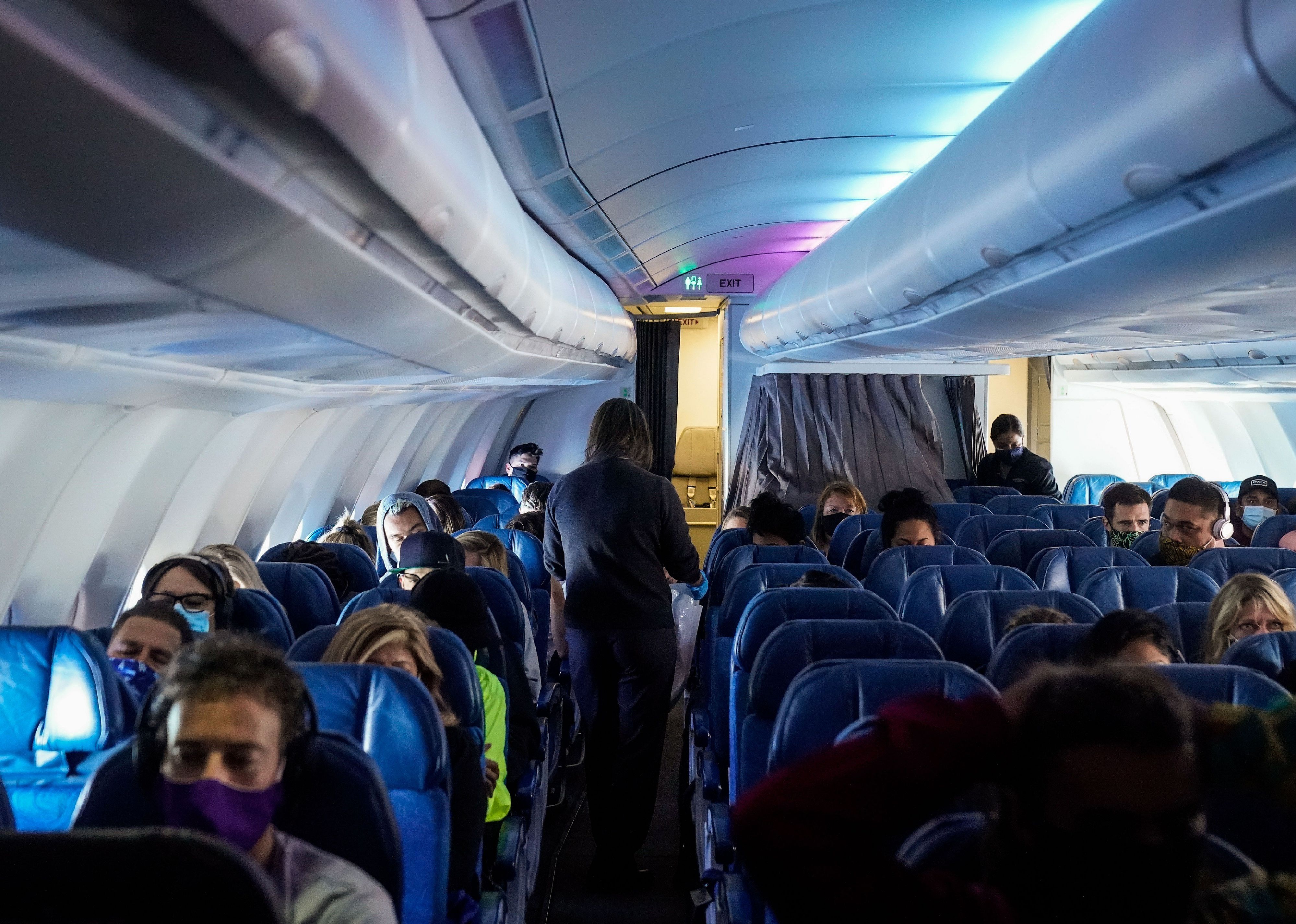 Masked passengers, aboard a Hawaiian Airlines flight.