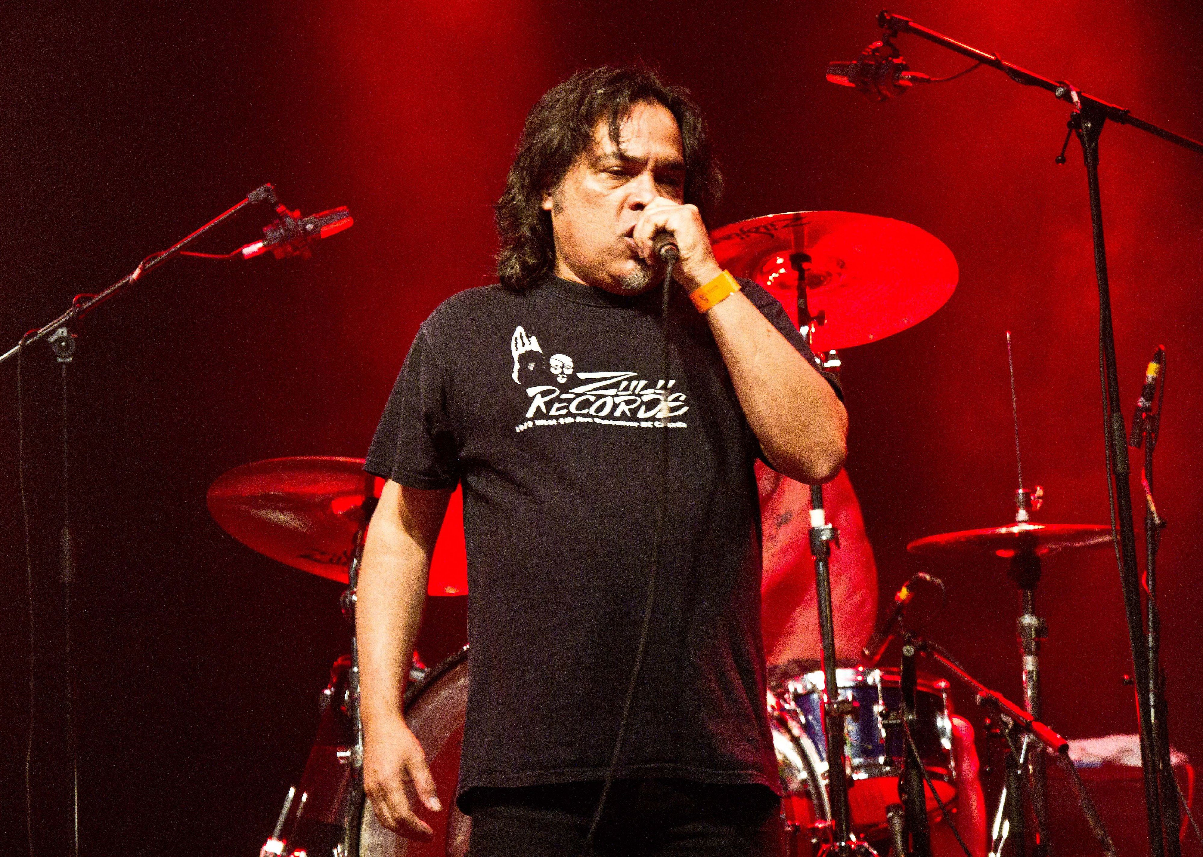 Black Flag on stage with a red background