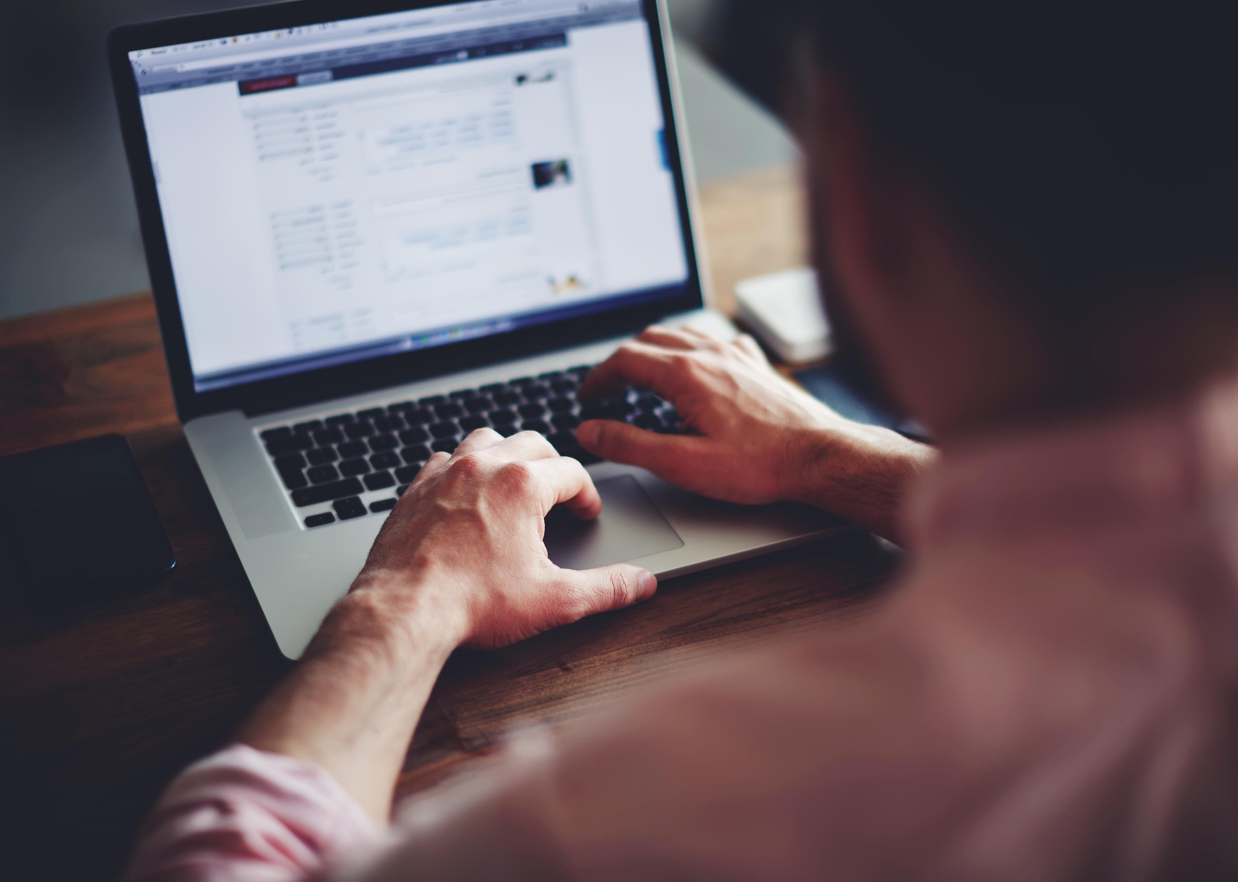 A man working on a laptop.