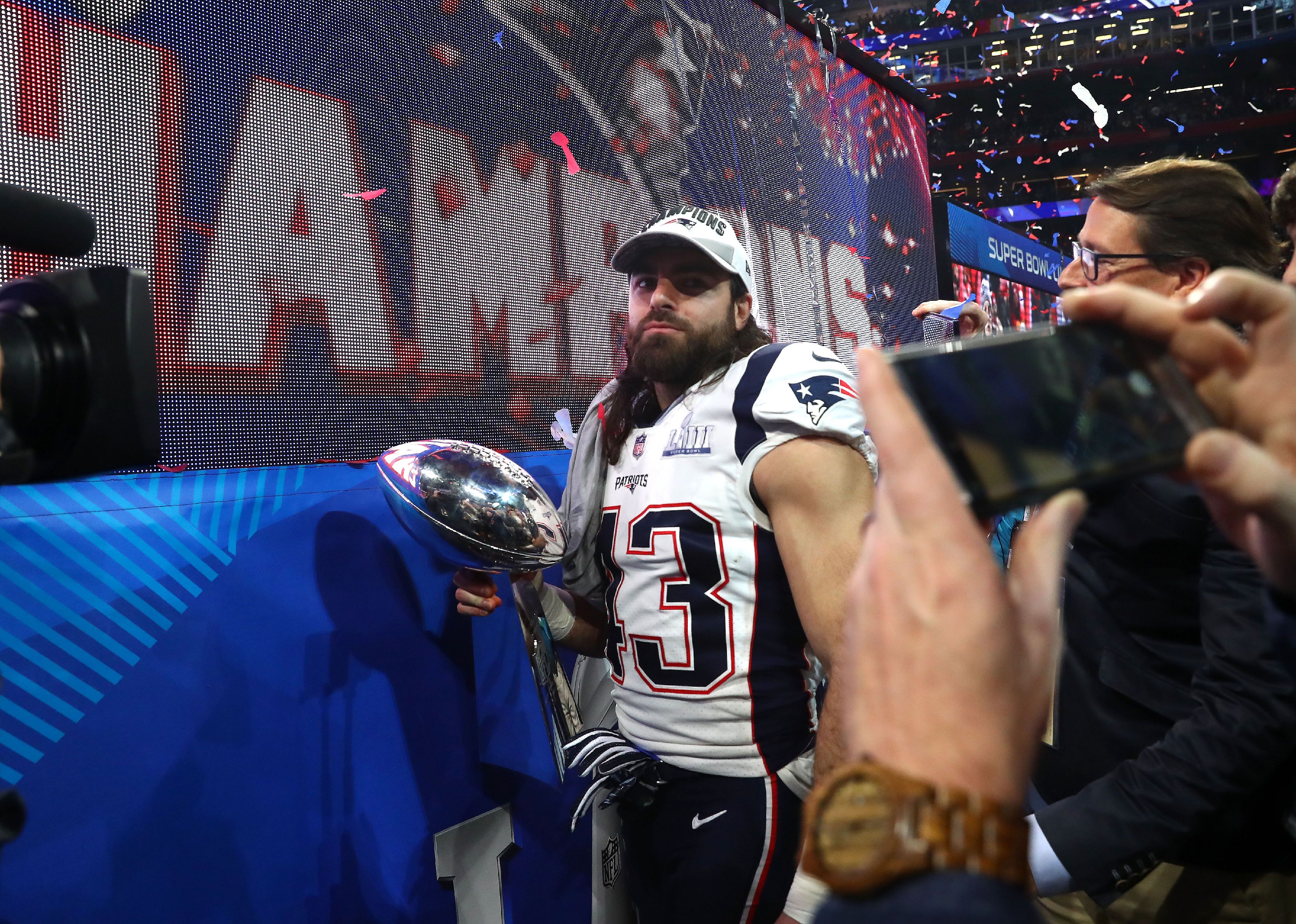 Nate Ebner of the New England Patriots celebrates with the Vince Lombardi Trophy.