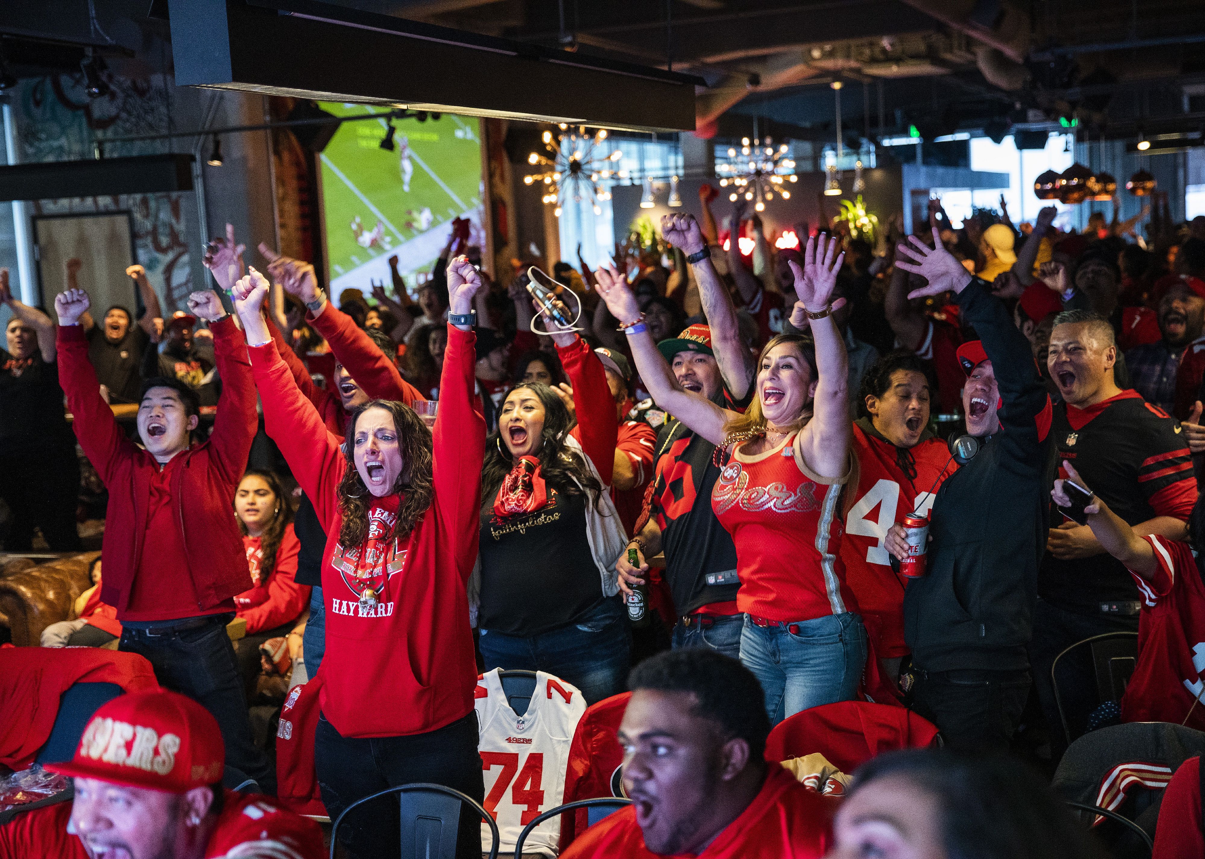 Fans react as they watch the San Francisco 49ers play the Kansas City Chiefs during Super Bowl LIV.