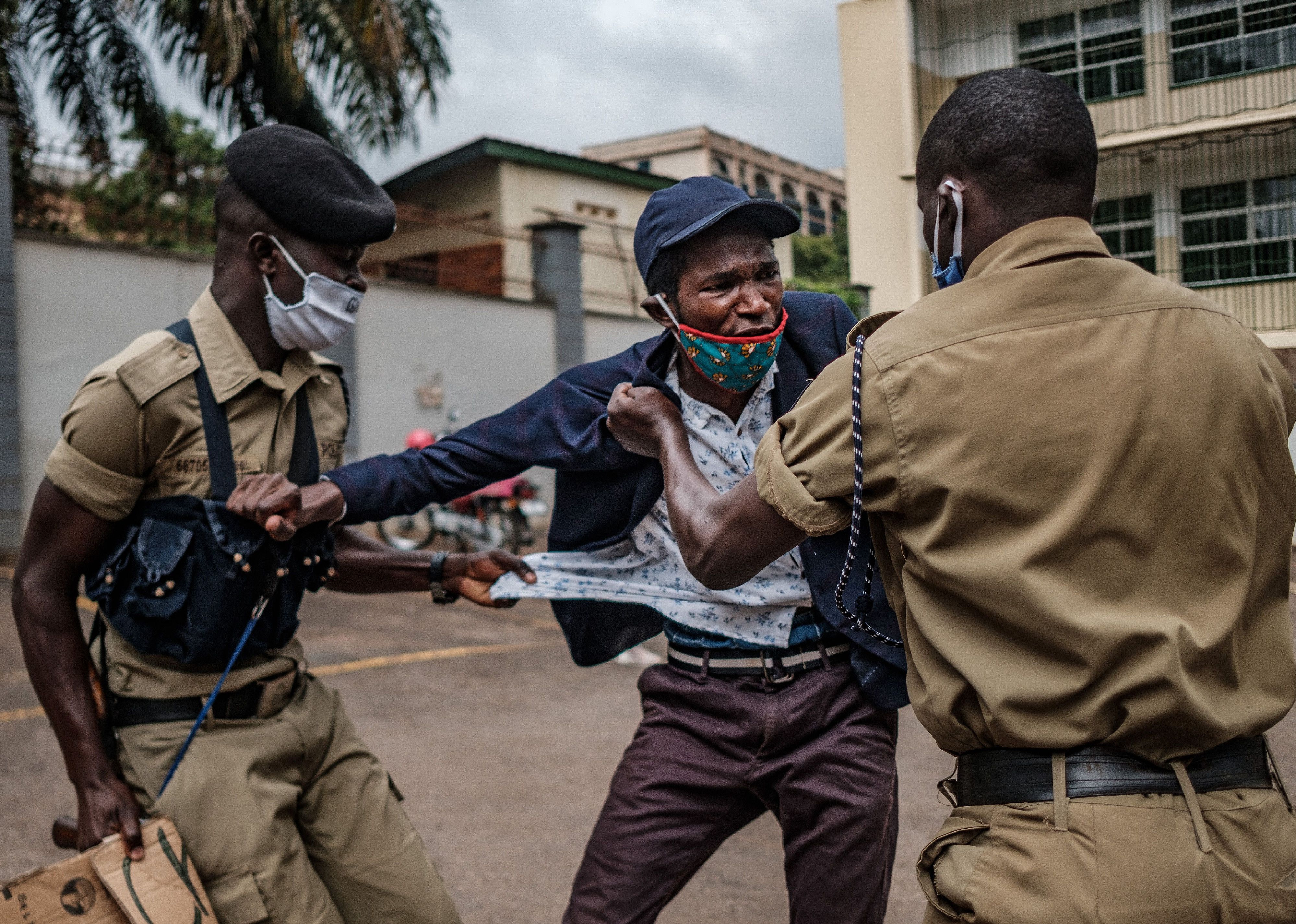 A protester is arrested by police officers