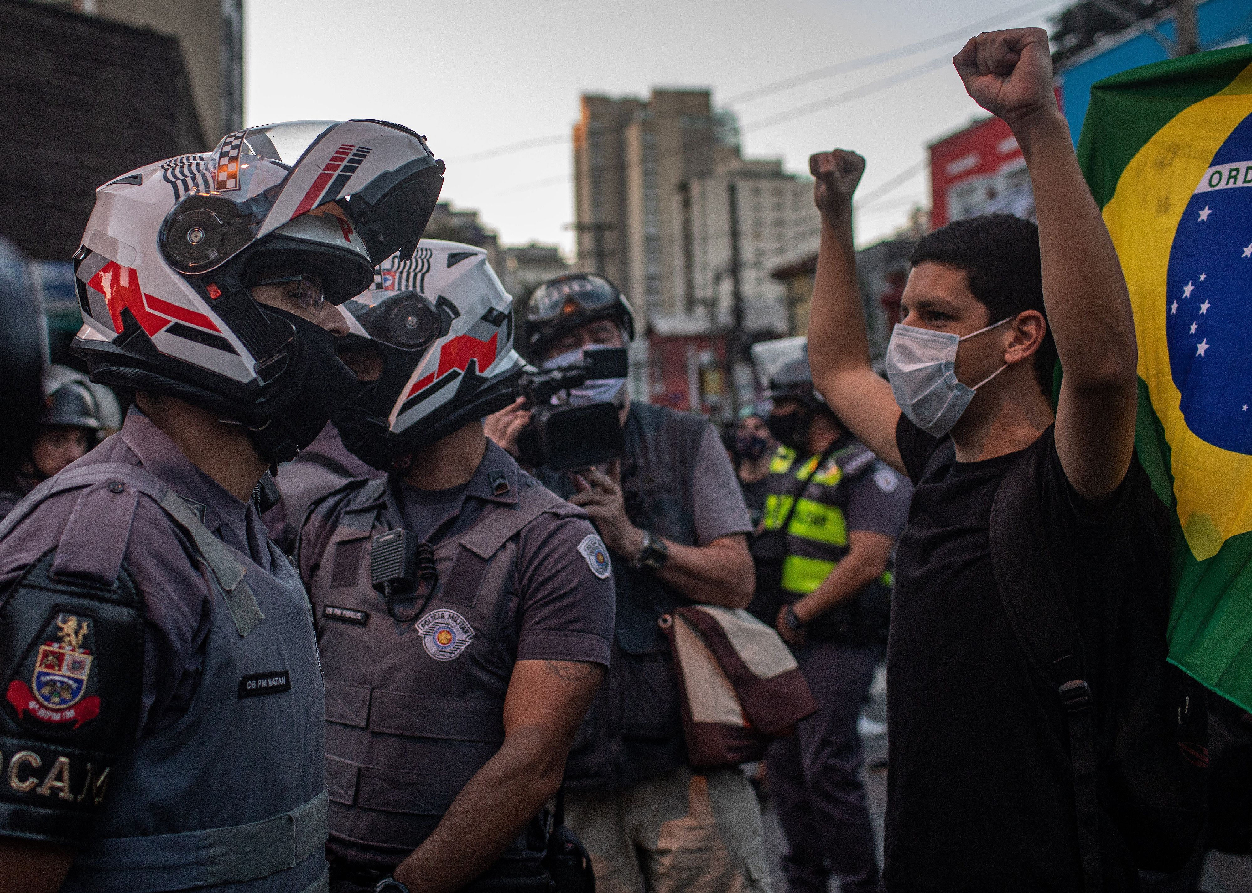 A protester faces off with the military police