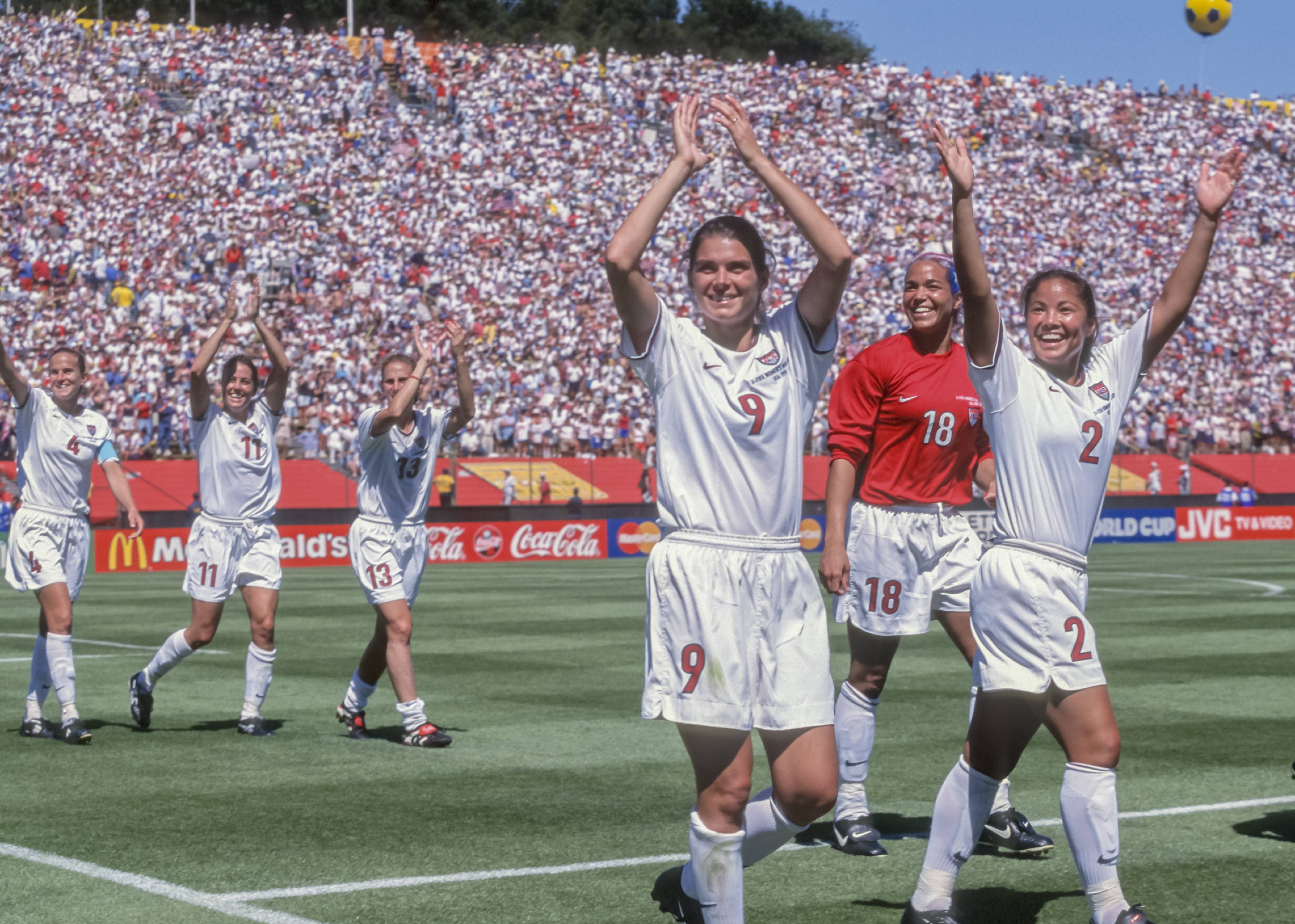 Mia Hamm, Saskia Webber, Lorrie Fair, Carla Overbeck, Julie Foudy, and Kristine Lilly of the USA Women's' Team salute the crowd