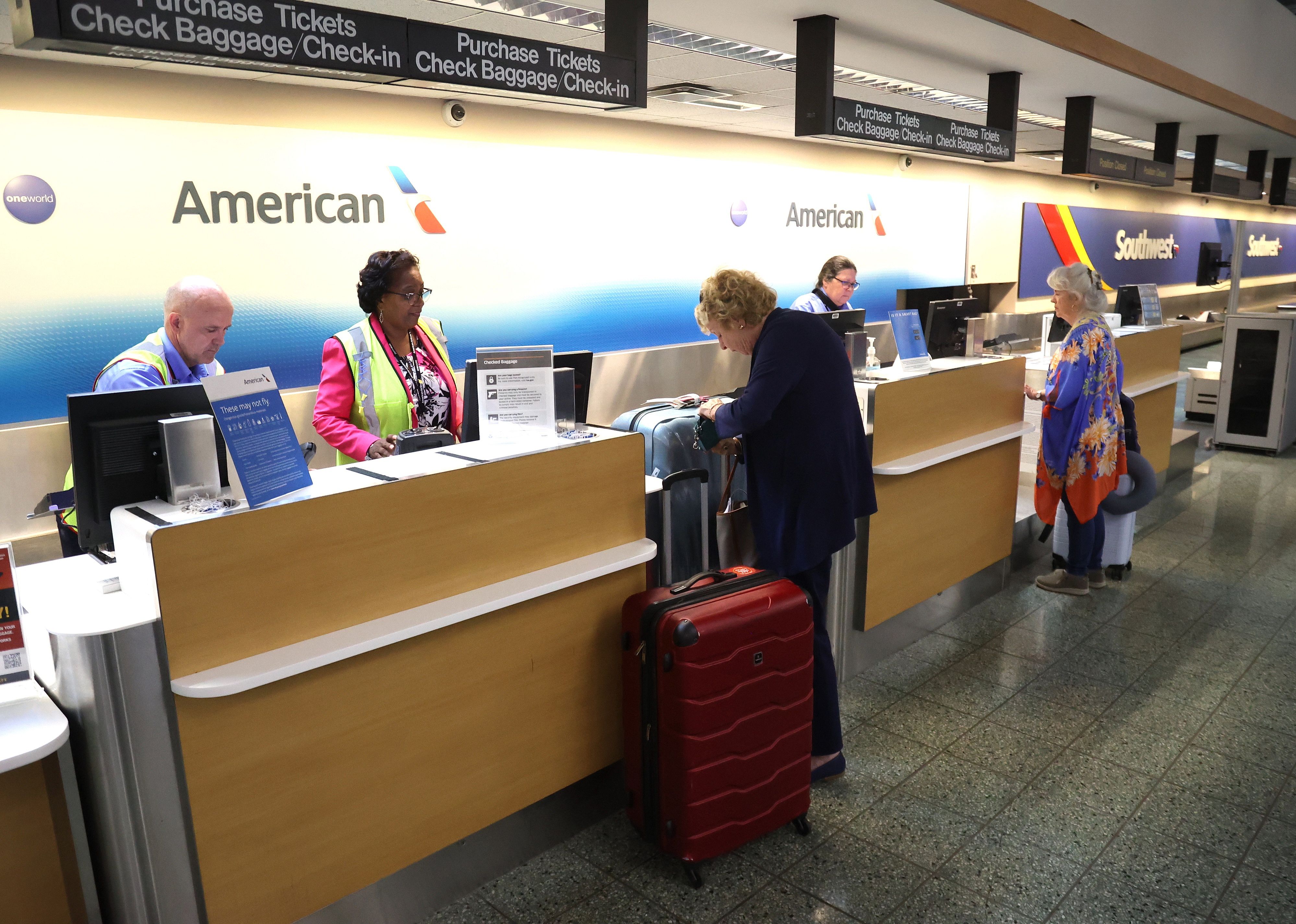 Passengers check-in for their flights on American Airlines at Long Island MacArthur Airport.