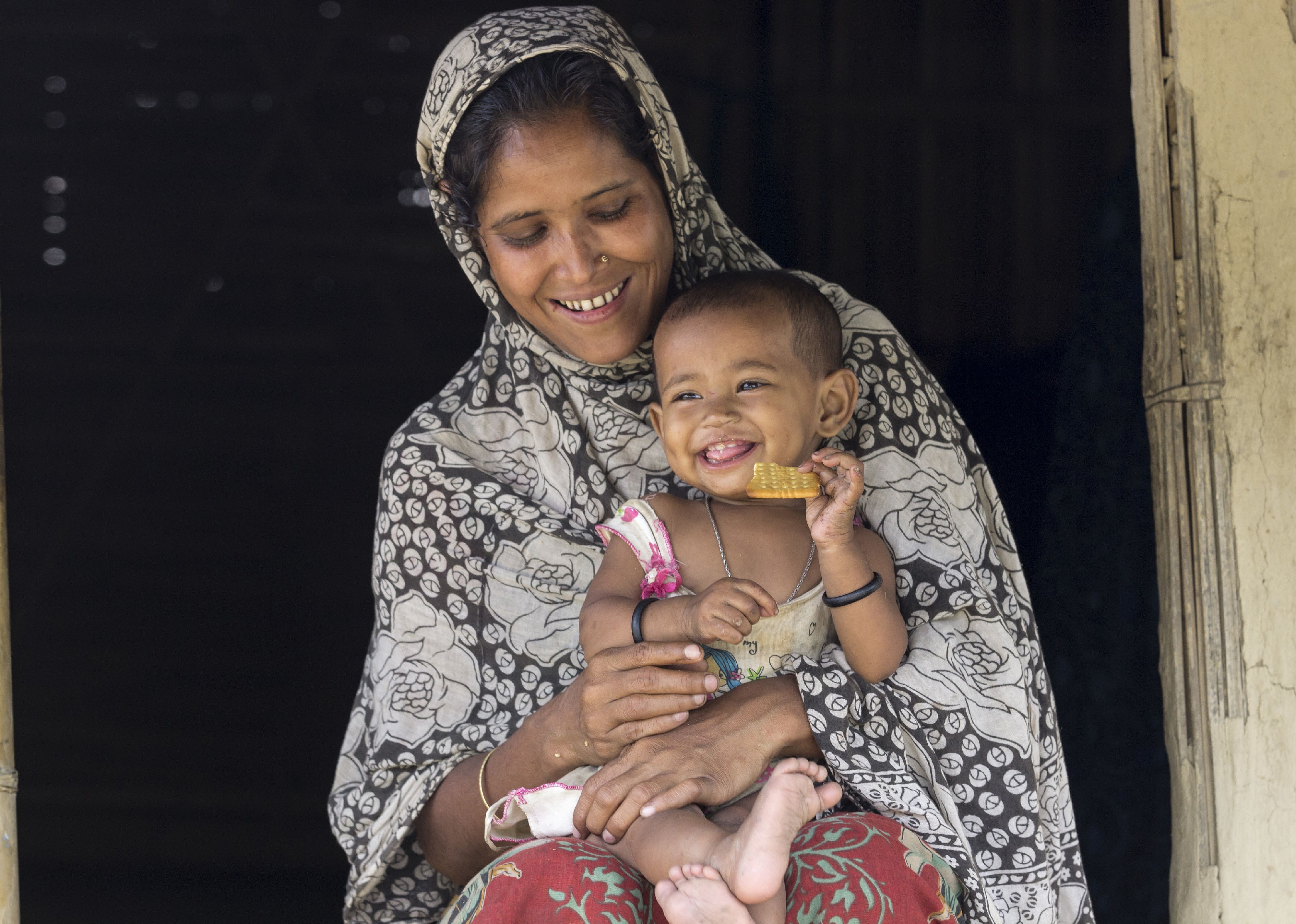 Front view of Indian woman with small child on her lap