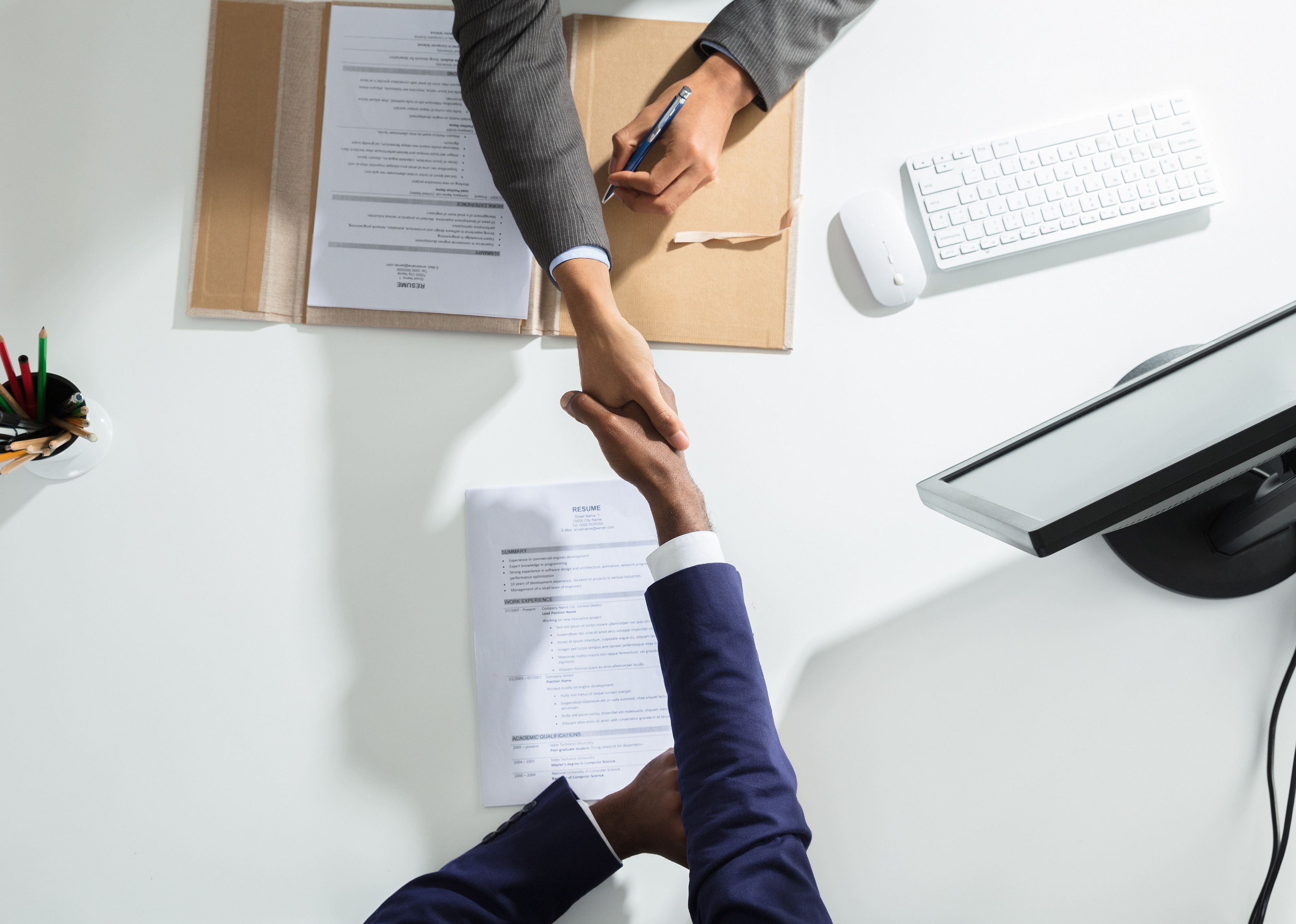 High Angle View of a businessperson shaking hand with a candidate