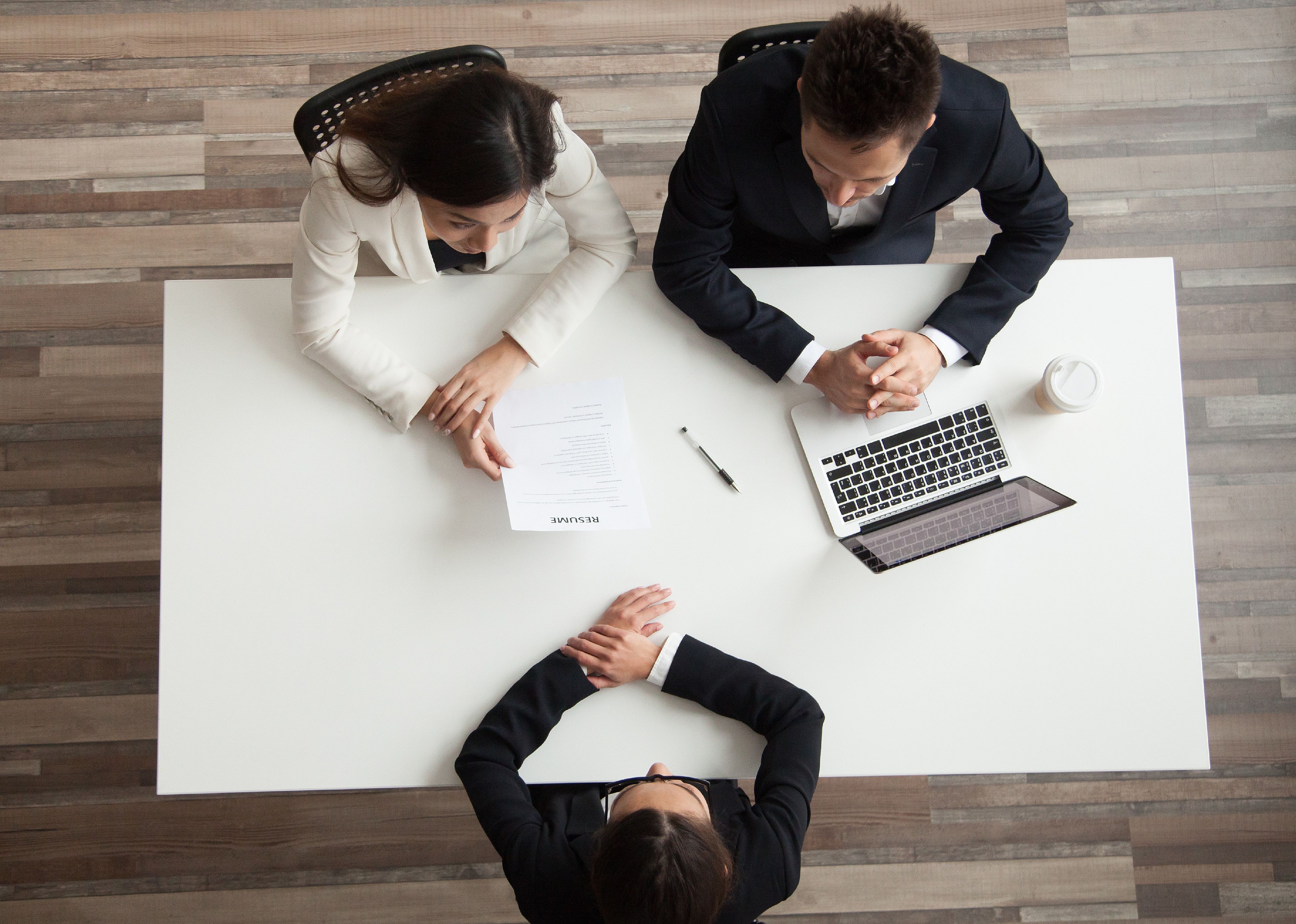 Top view of HR managers interviewing job applicant
