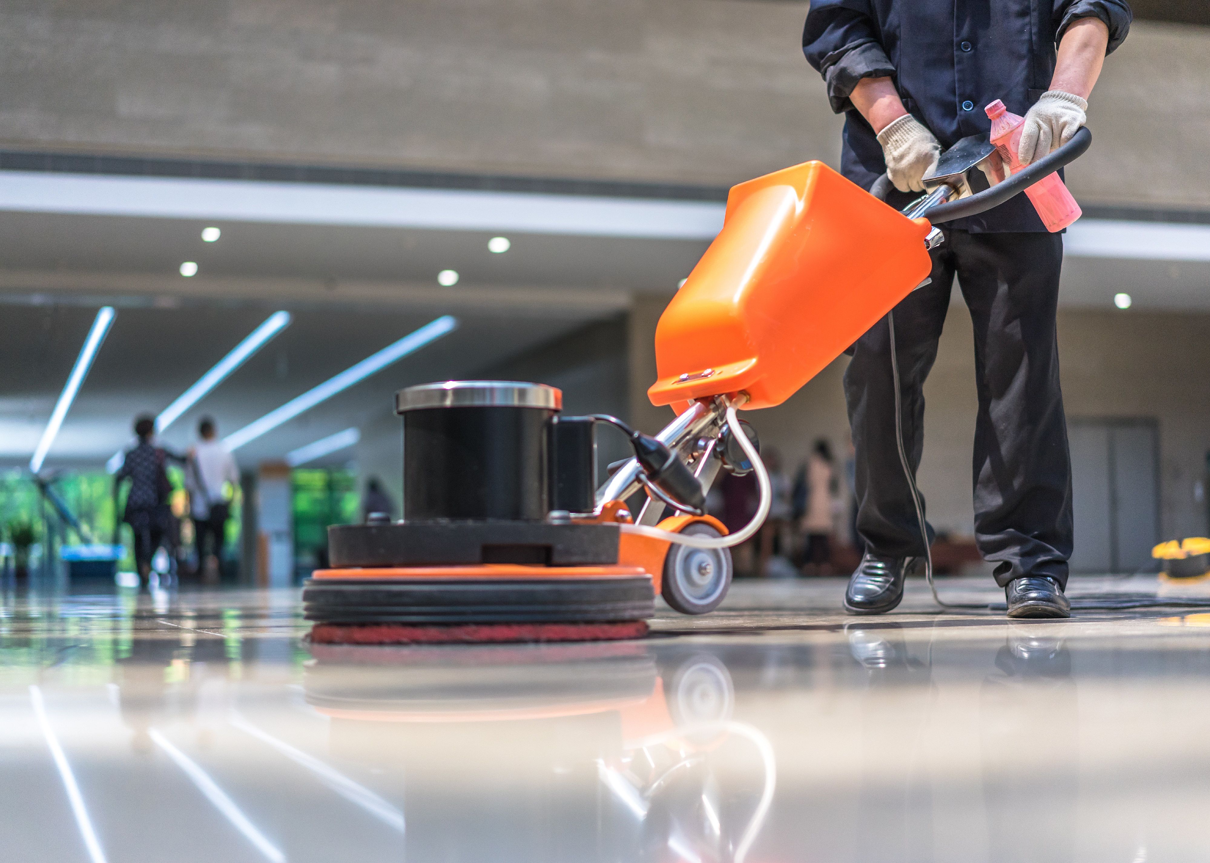 Cleaning worker polishes a floor