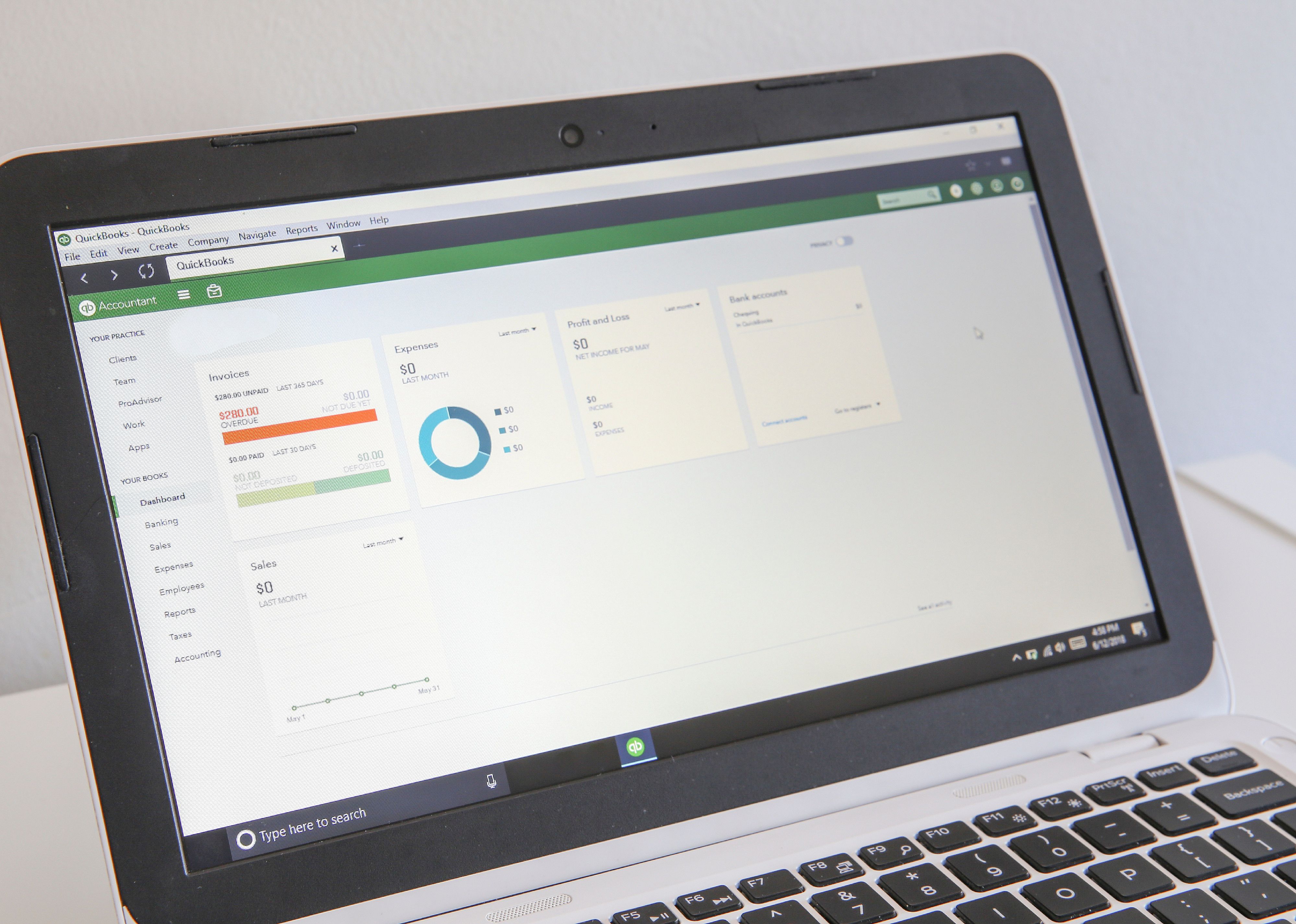 QuickBooks software displayed on laptop.