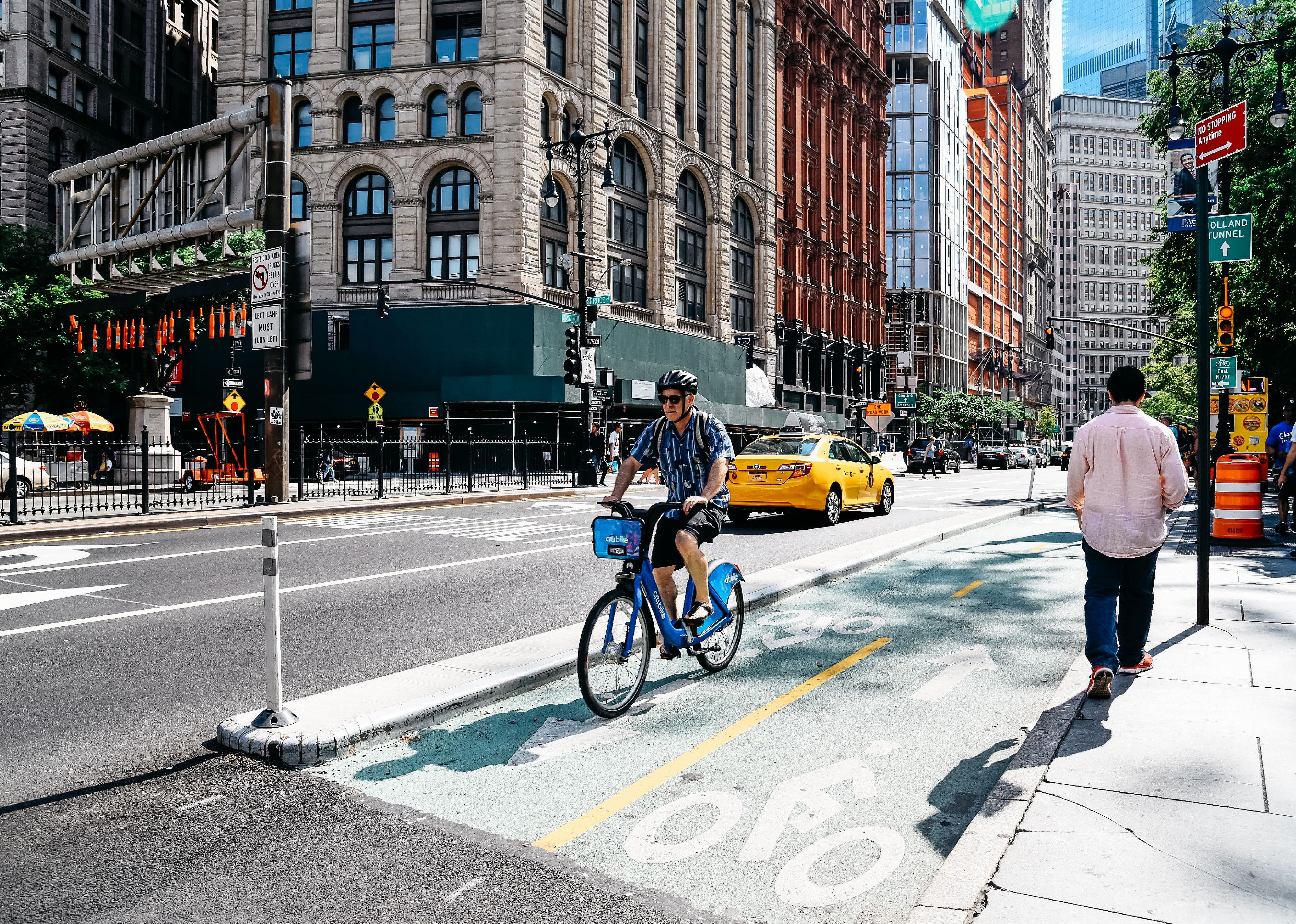 Cyclist riding on bike lane in Park Row in Financial District