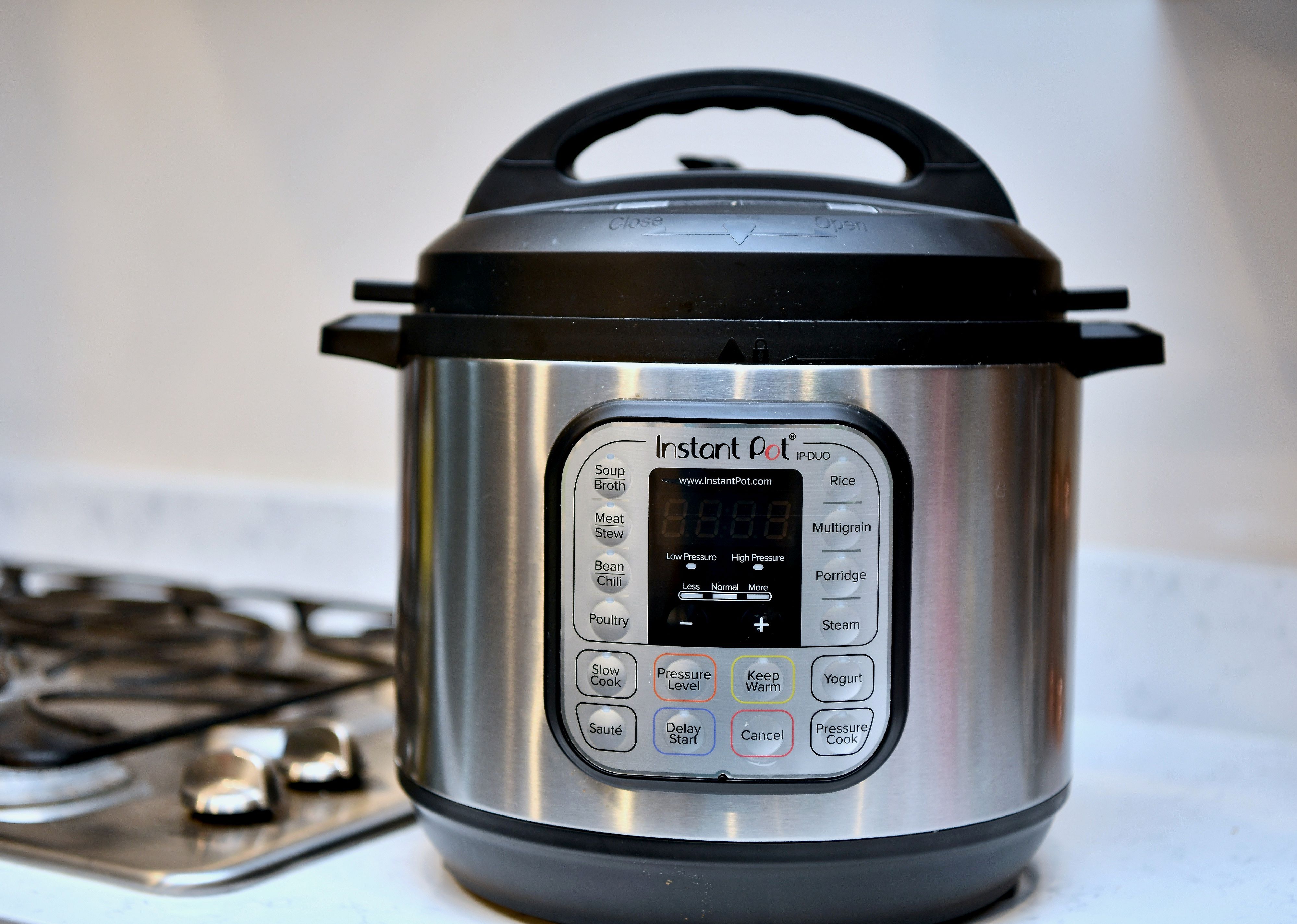 Instant Pot on counter next to stove.