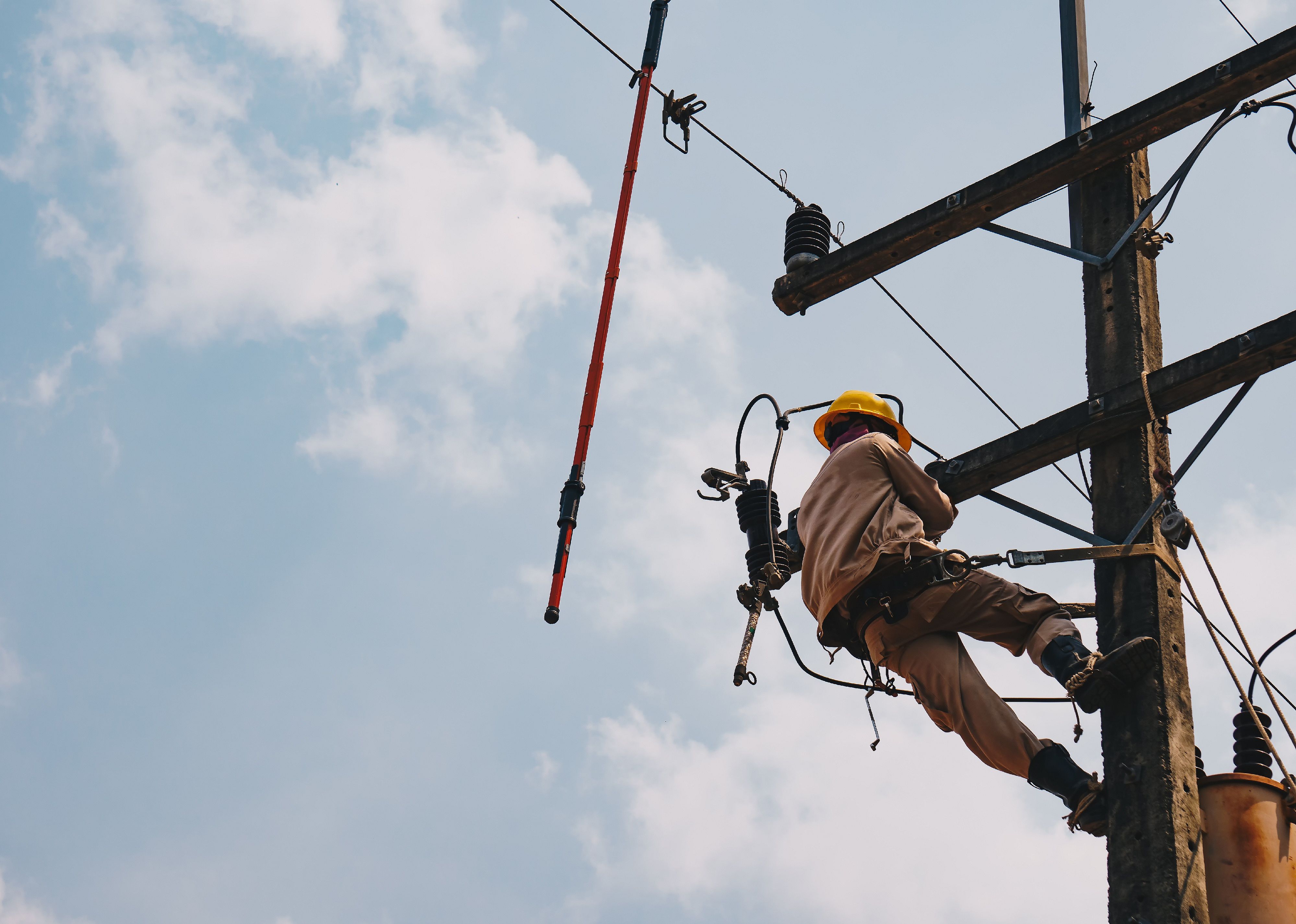 Lineman using an insutated tool.