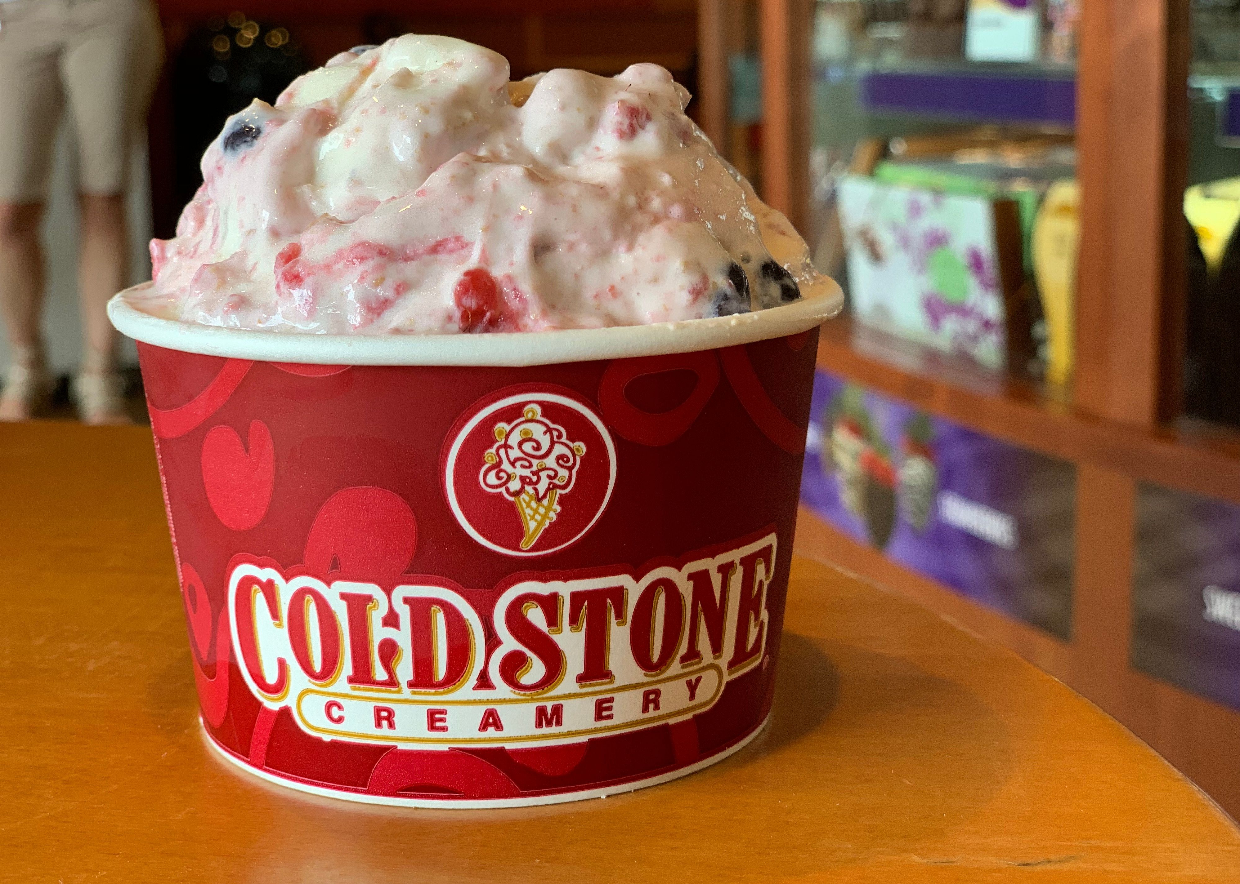 Ice cream in a cup on a table at Cold Stone Creamery.