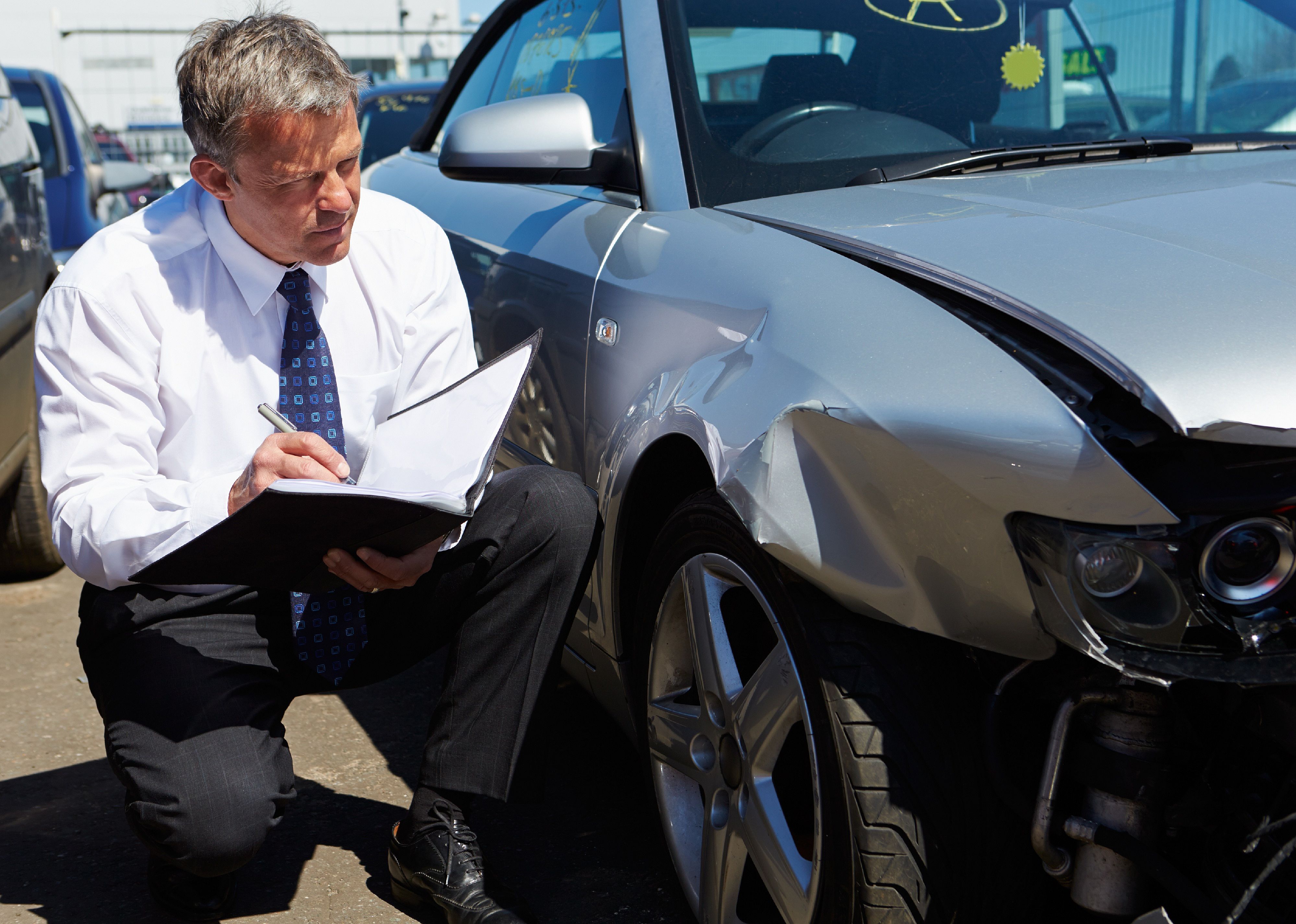 Agent inspecting car involved in accident