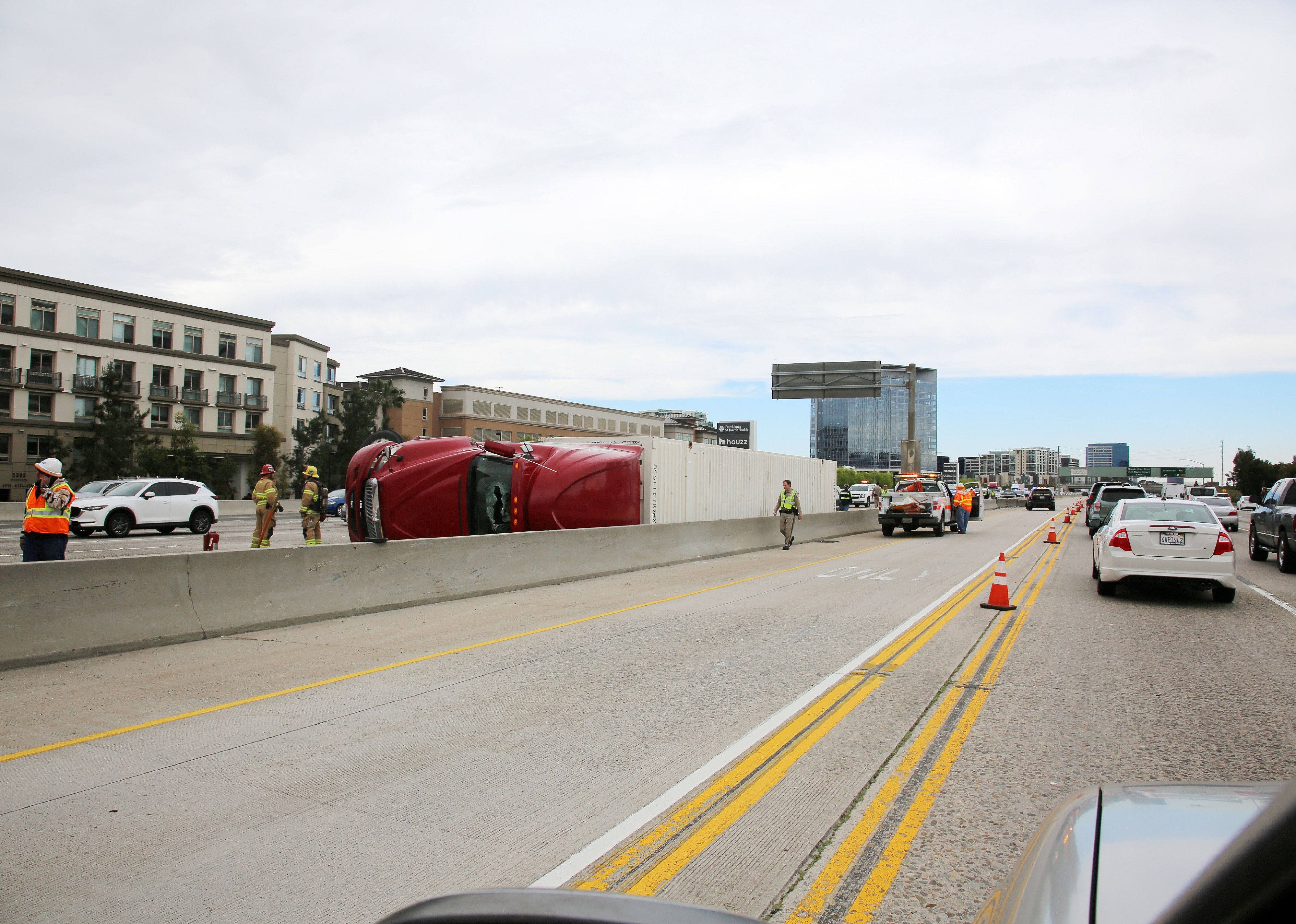 Semi truck and cargo on its side on the freeway after an accident