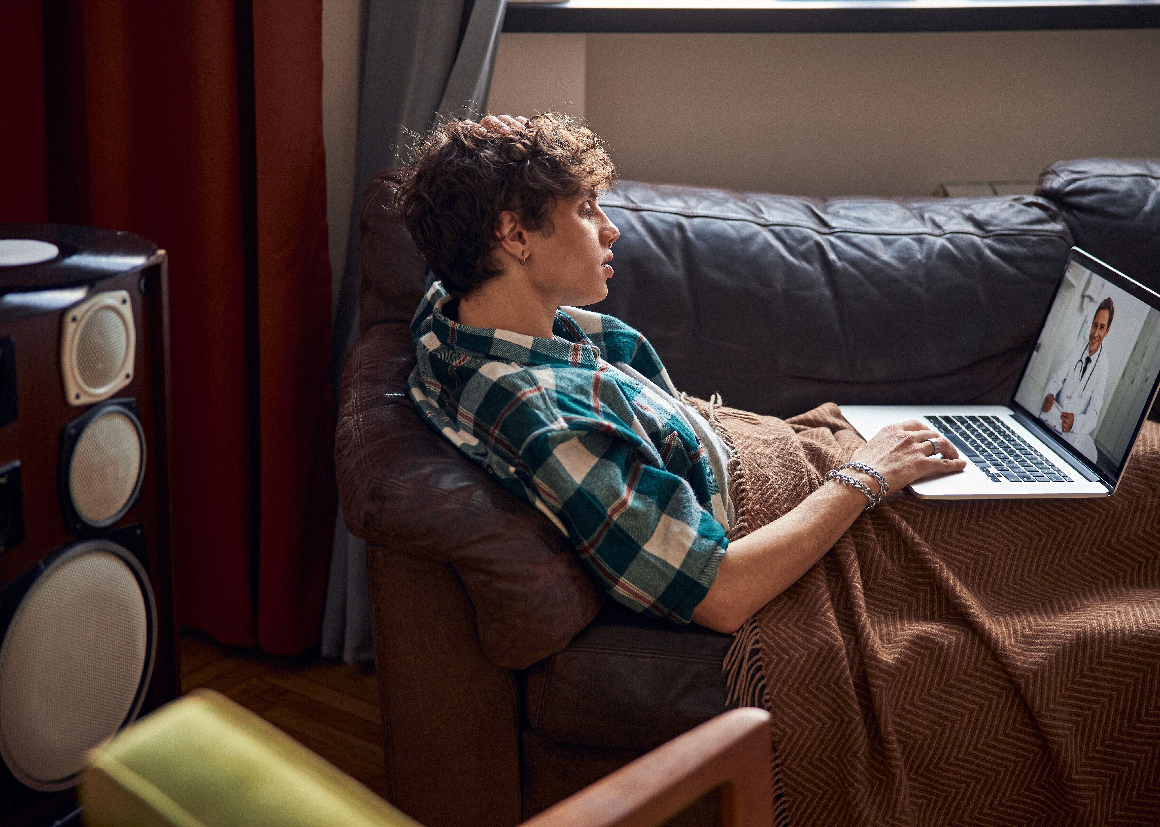 Young man having online consultation with doctor