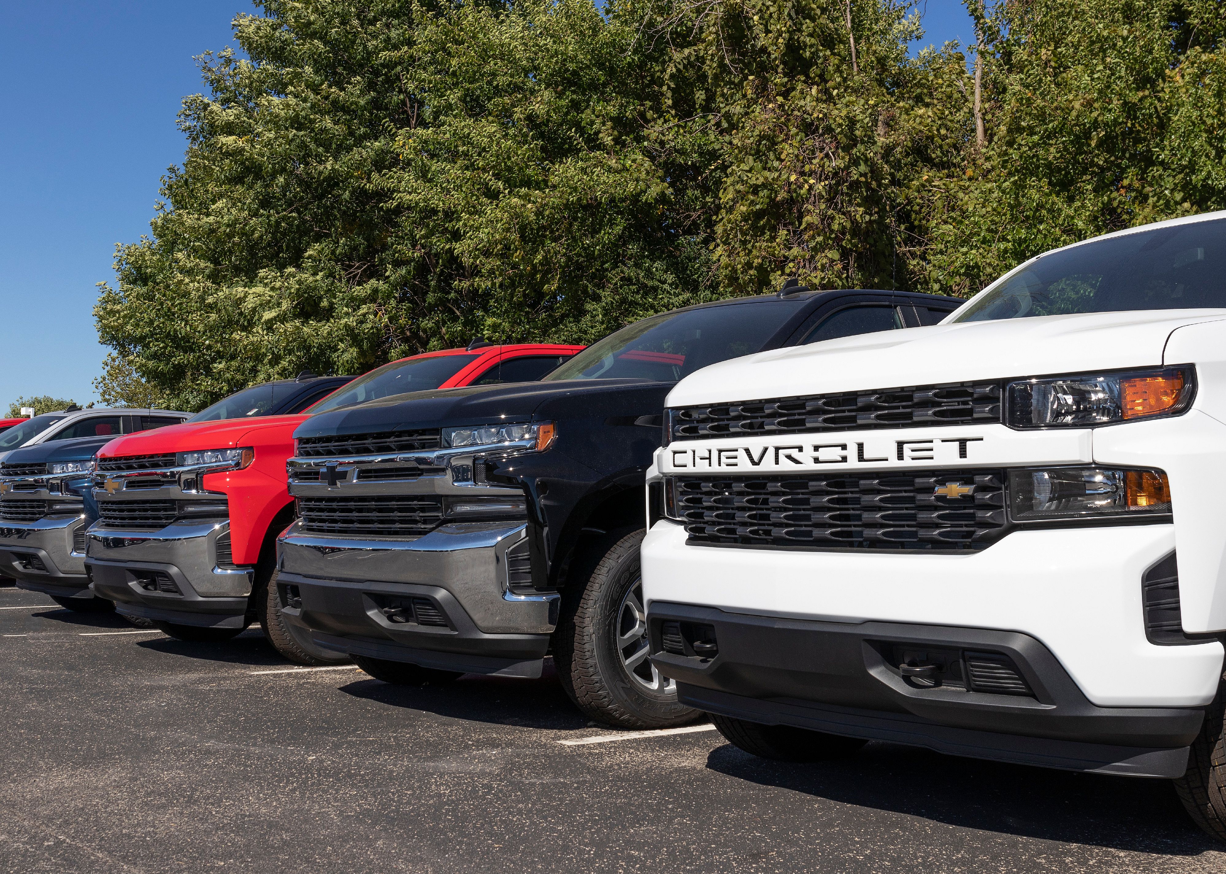 Chevrolet Silverado pickup trucks on display at a dealership.