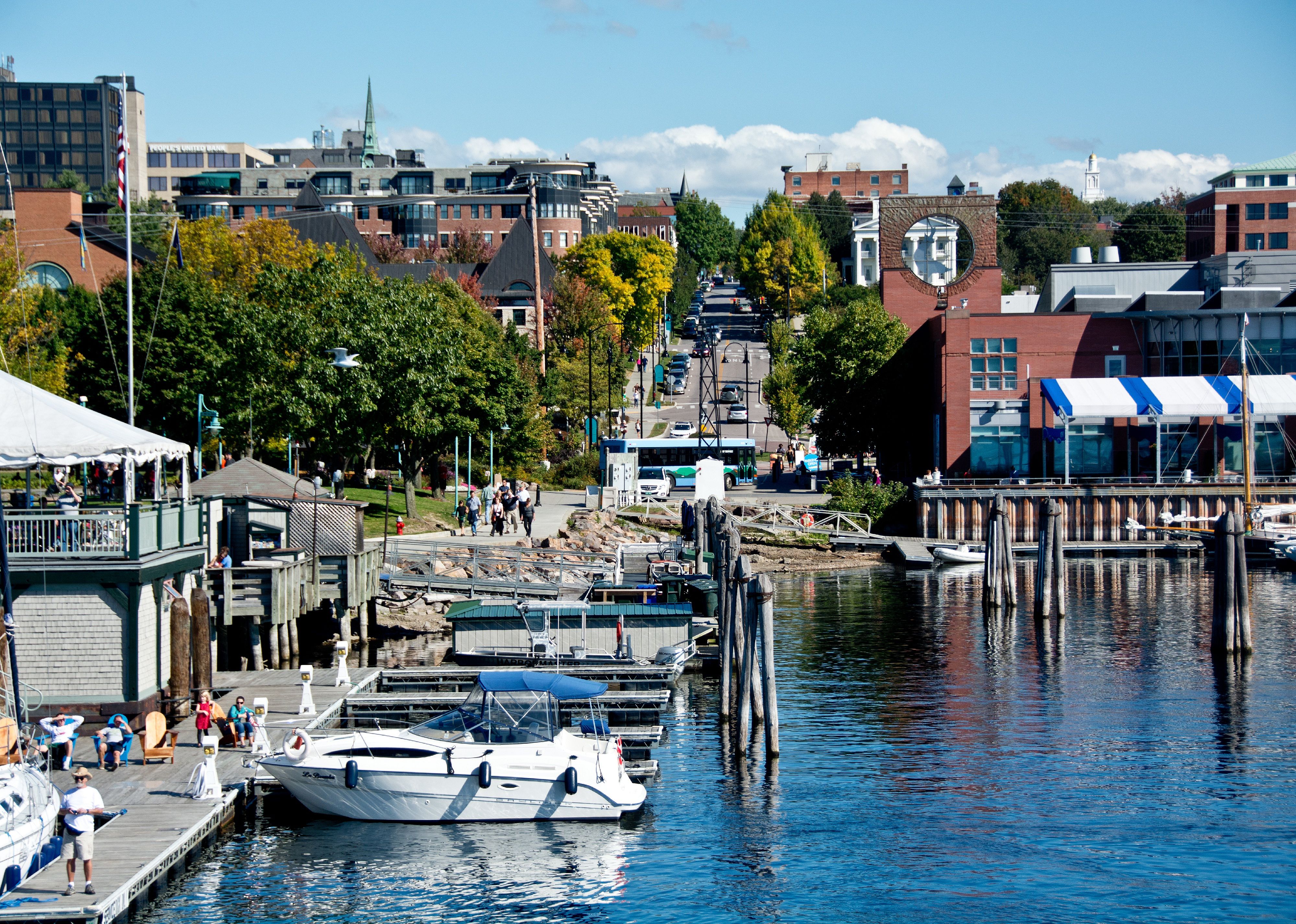 People gather to watch boats along the water at the Burlington Marina.