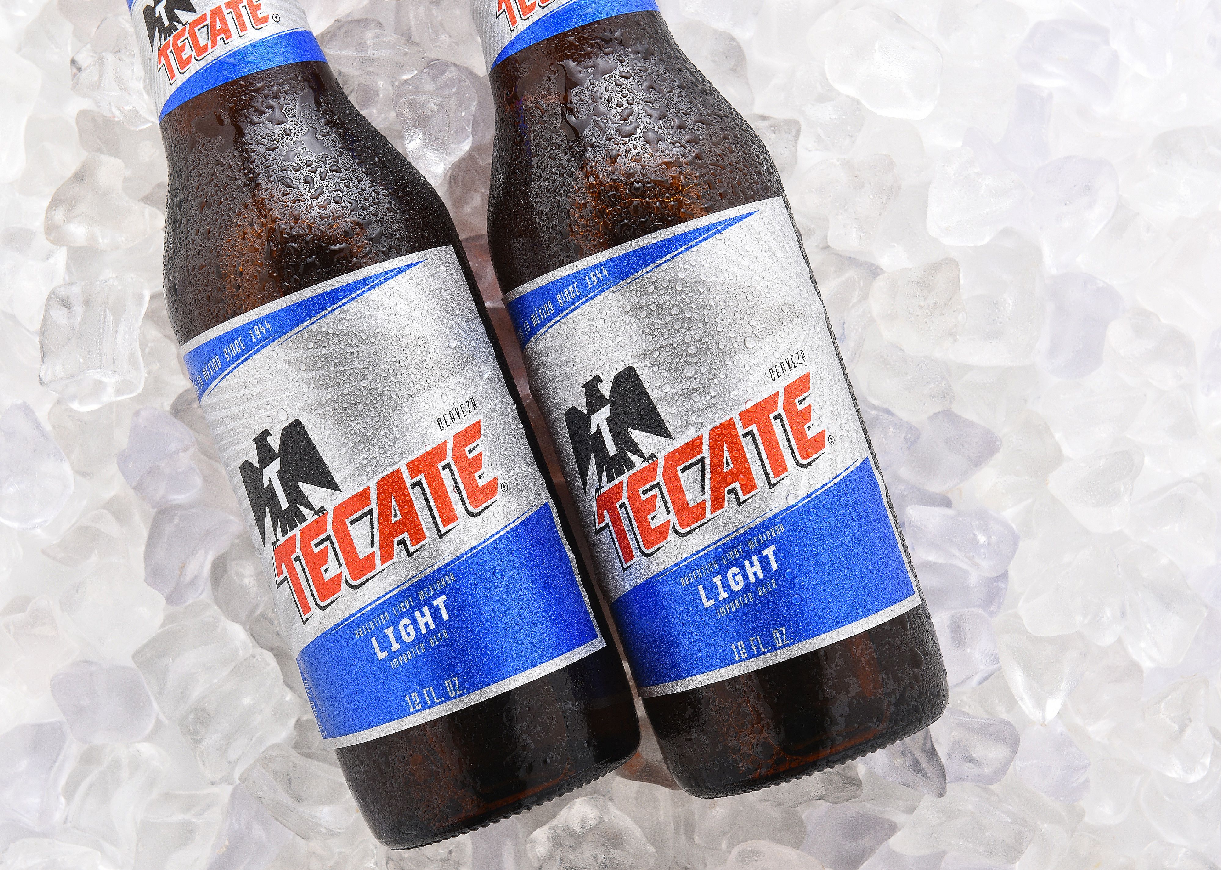 Tecate Light bottles on ice