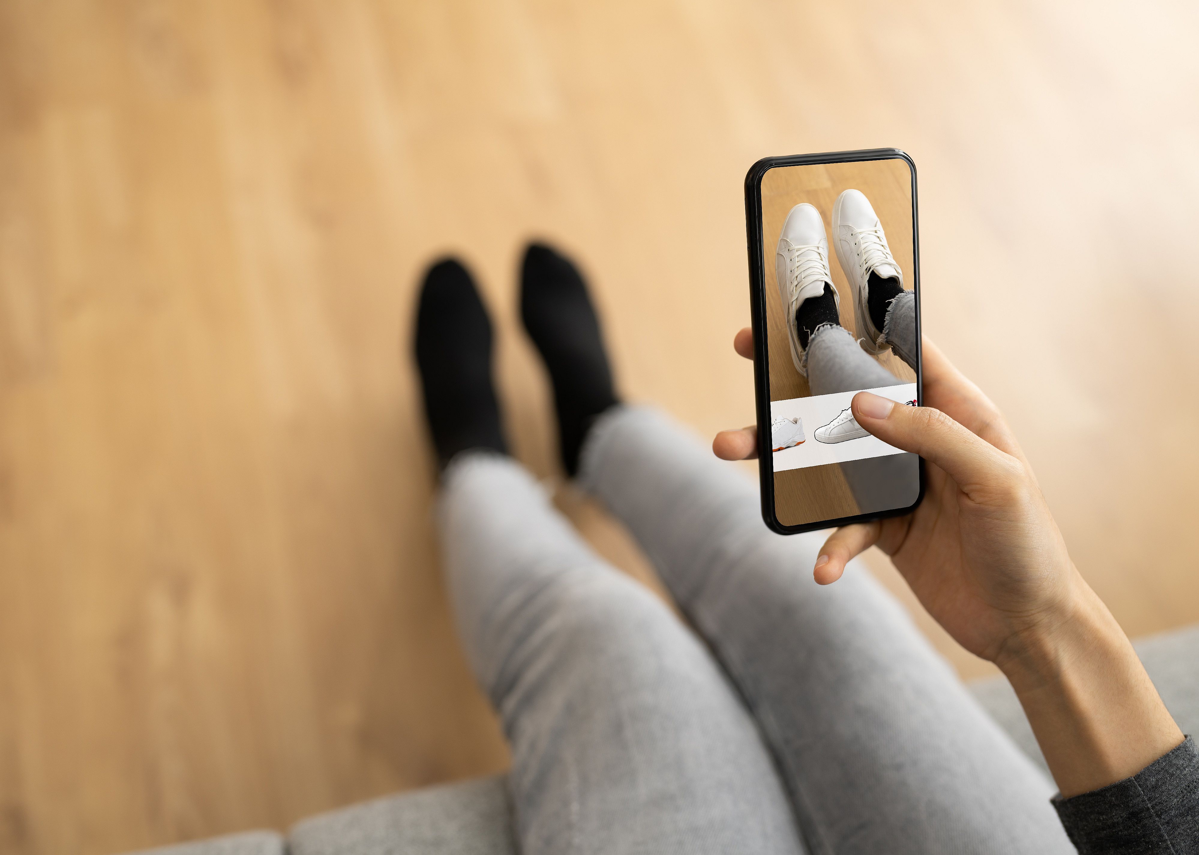 Woman trying virtual shoes through AR store app