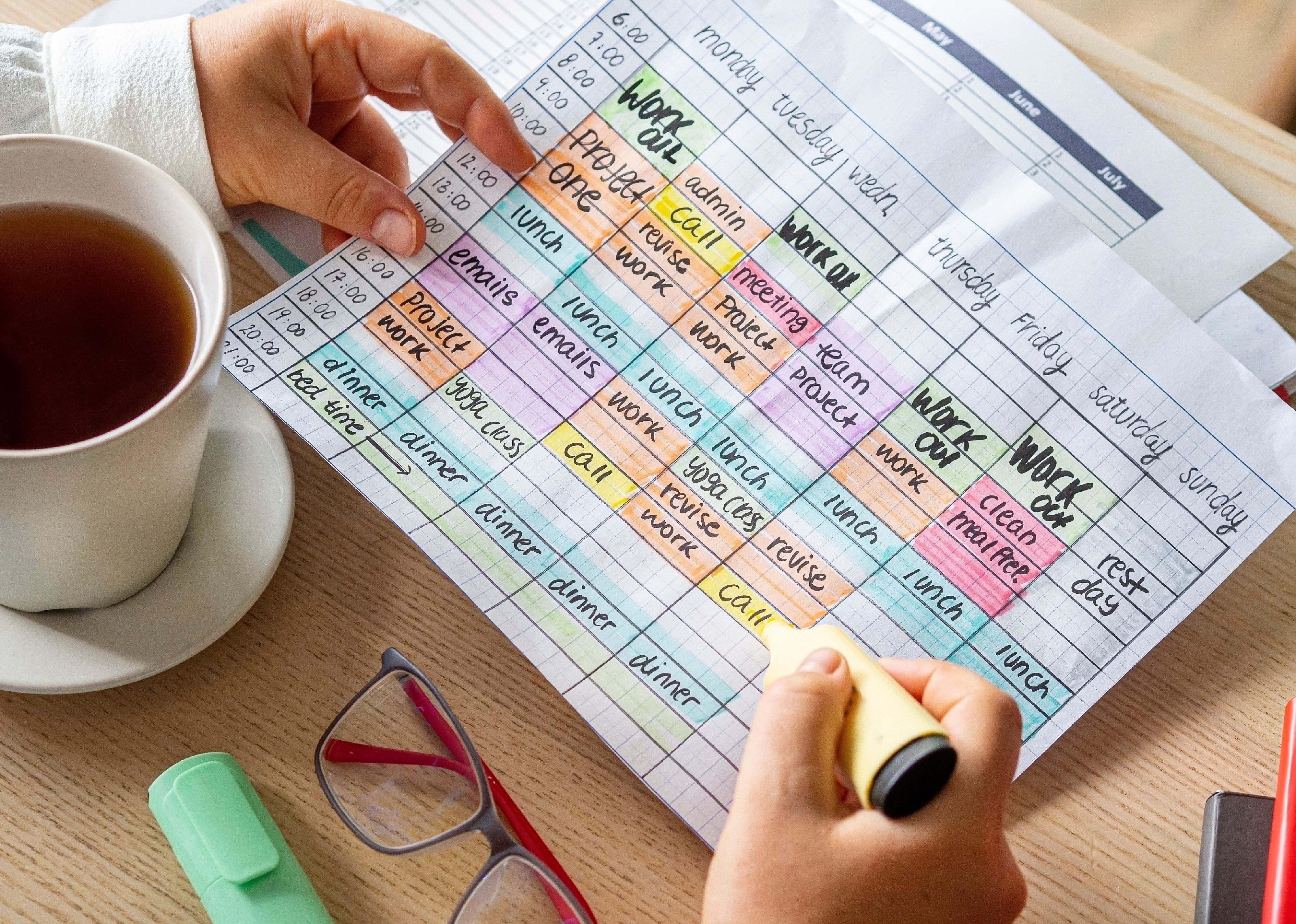 Person holding a time blocking weekly calendar.