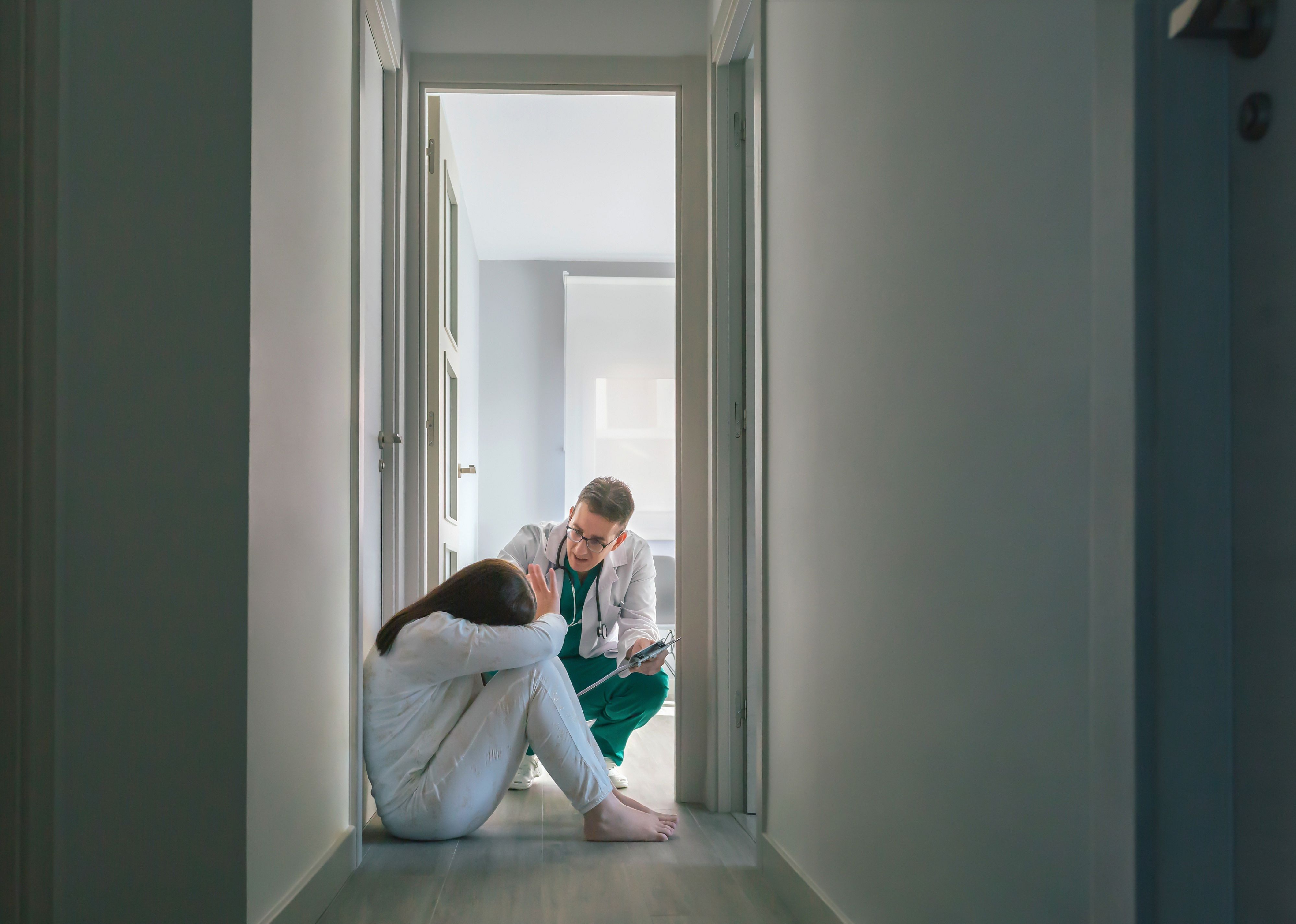 Doctor trying to help woman patient in the hospital.