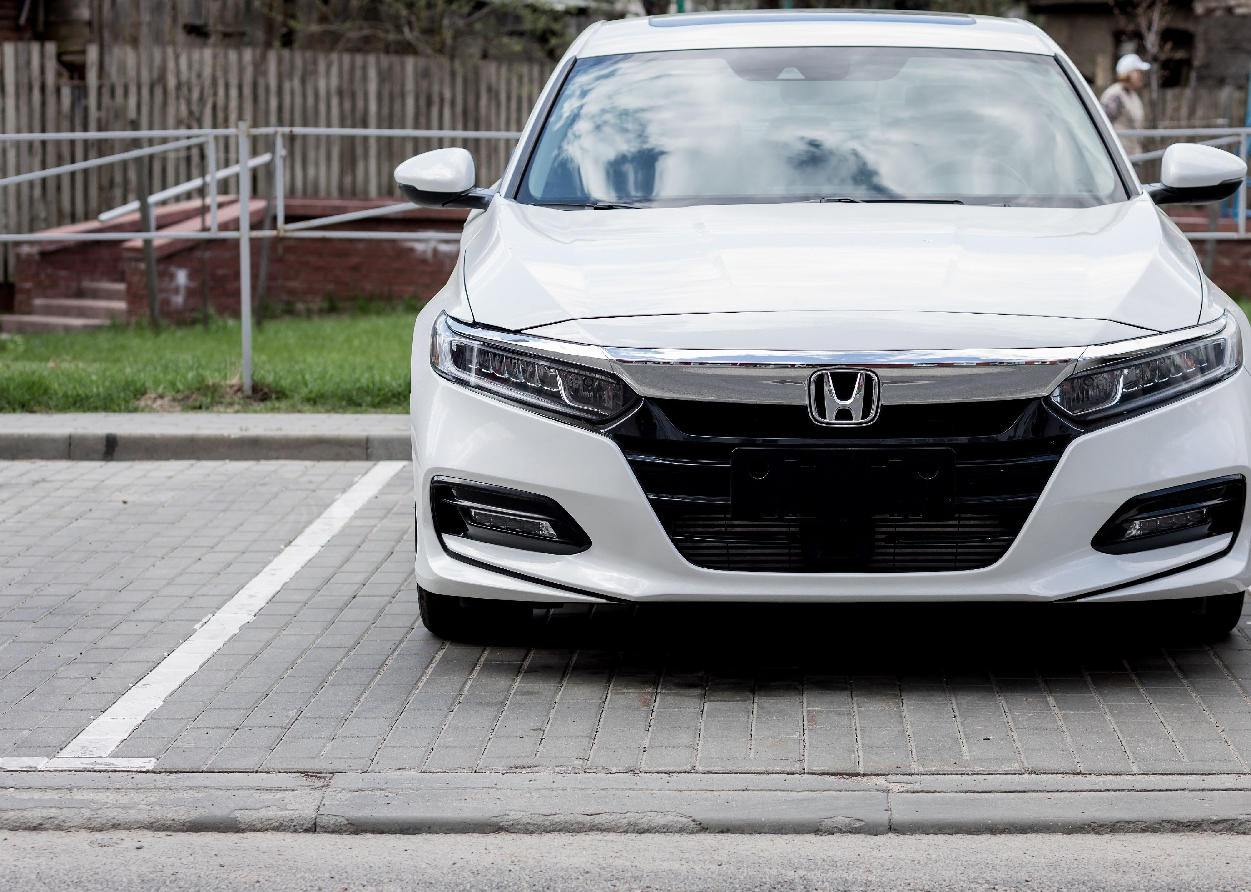 A white Honda Accord parked in a parking space.