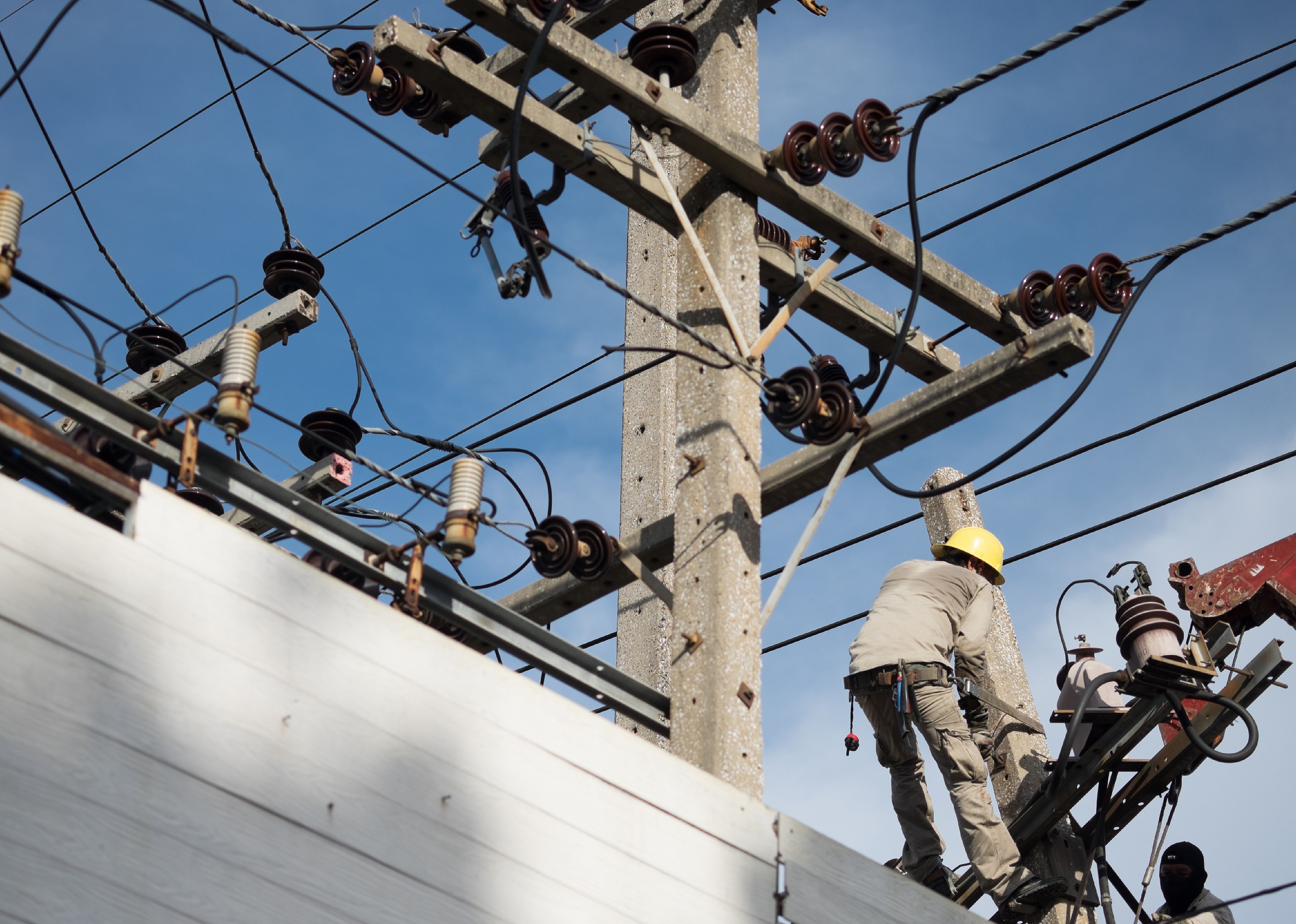 Linemen repairing broken power line.