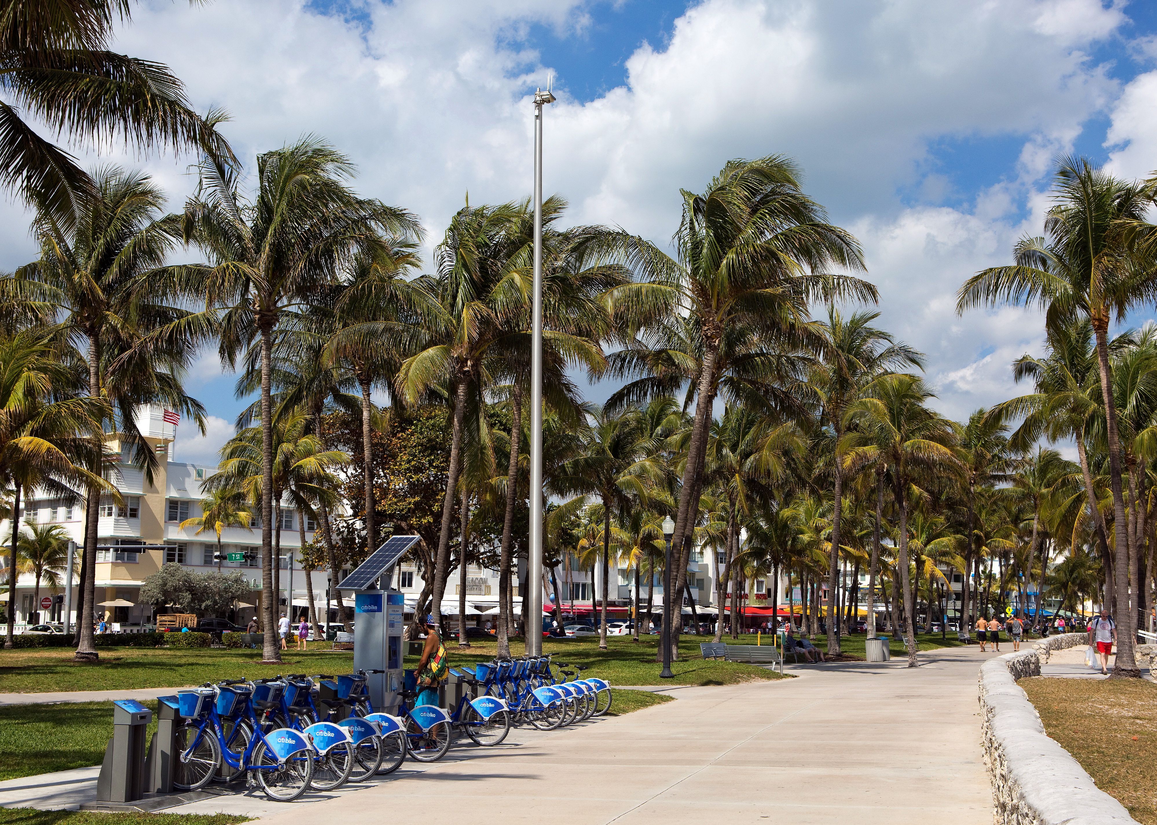 Man uses a self-service kiosk station to rent a bicycle on Ocean Drive in Miami Beach