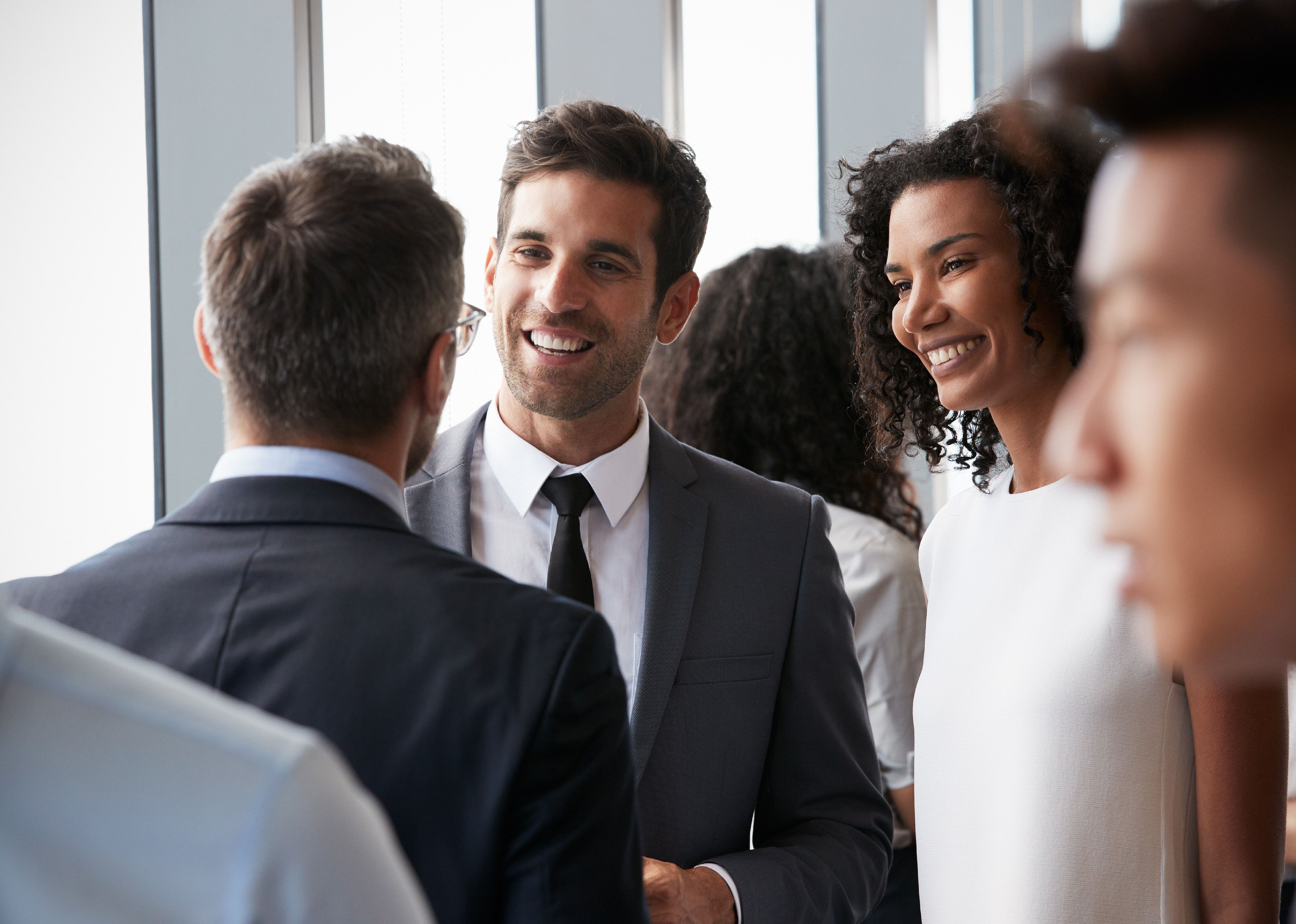 Group of business people speaking in a group.