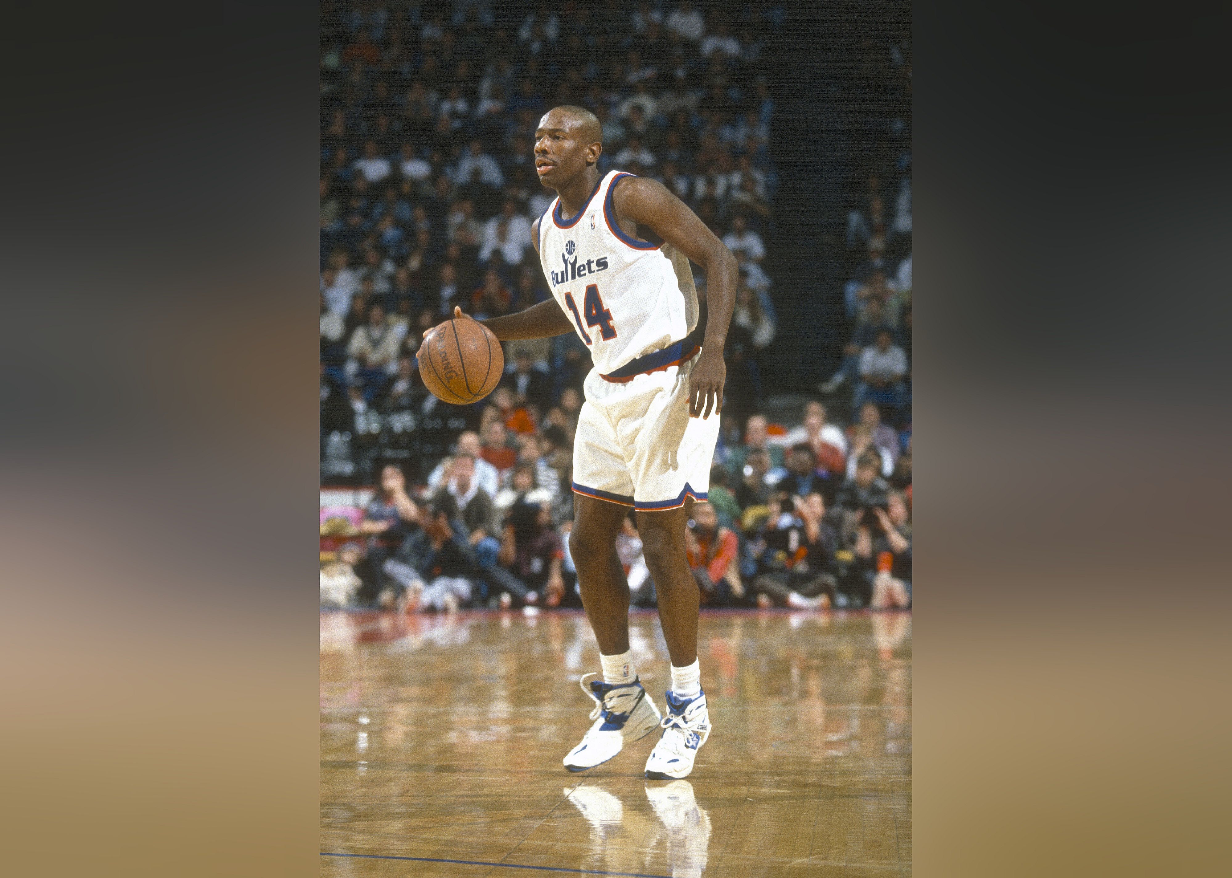 Doug Overton of the Washington Bullets dribbles the ball during a basketball game.