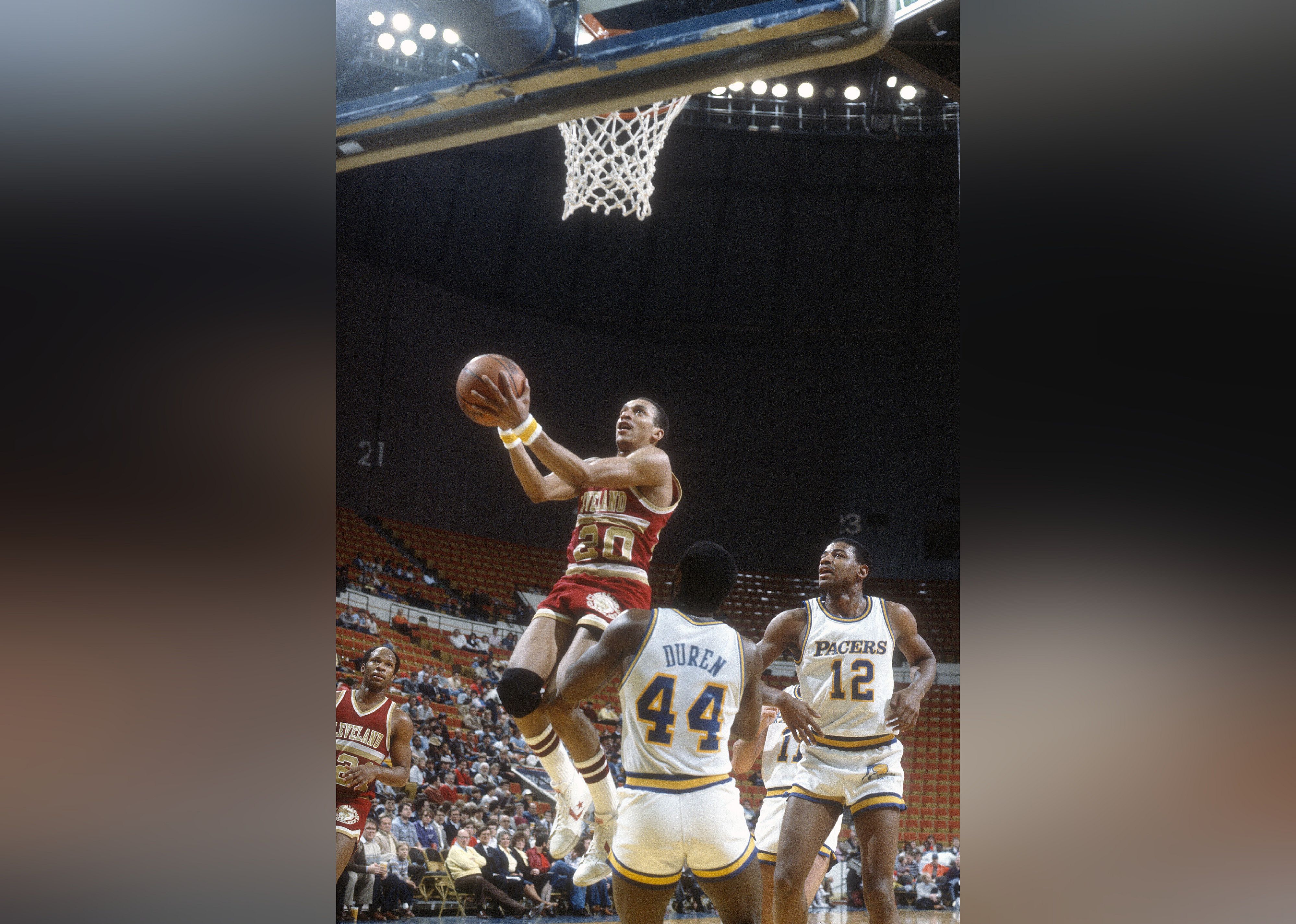 Geoff Huston of the Cleveland Cavaliers goes up to shoots over John Duren of the Indiana Pacers.