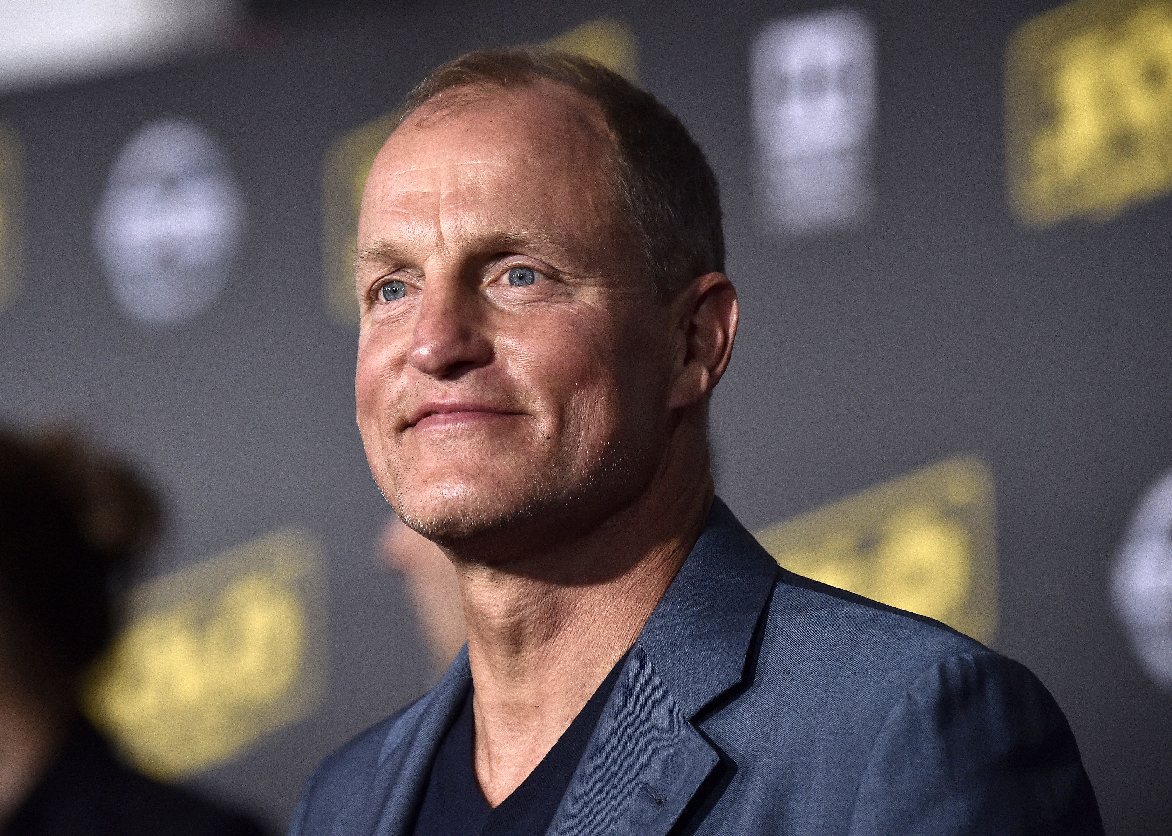 Woody Harrelson in a blue blazer.
