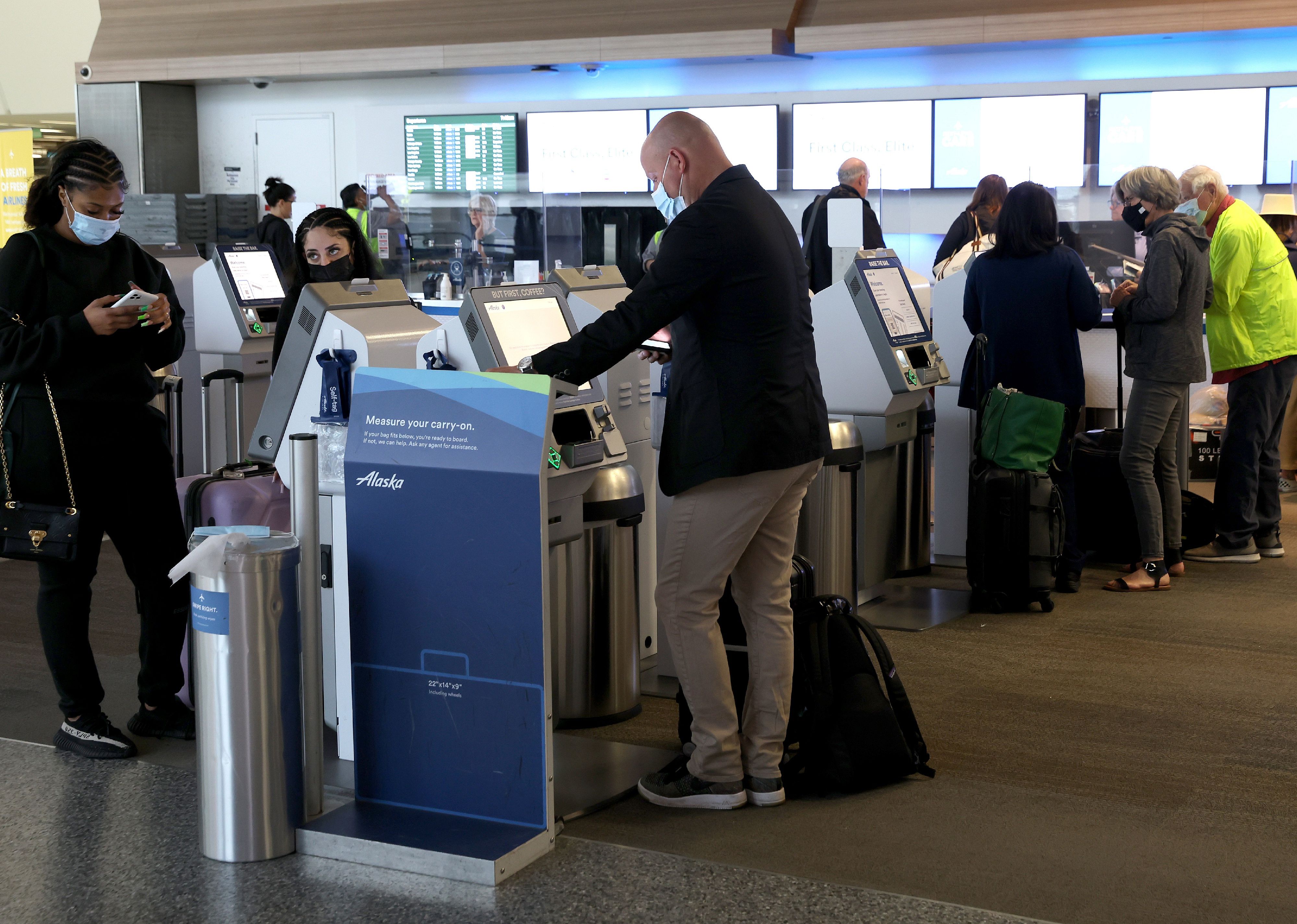 Alaska Airlines passengers check in for flights.