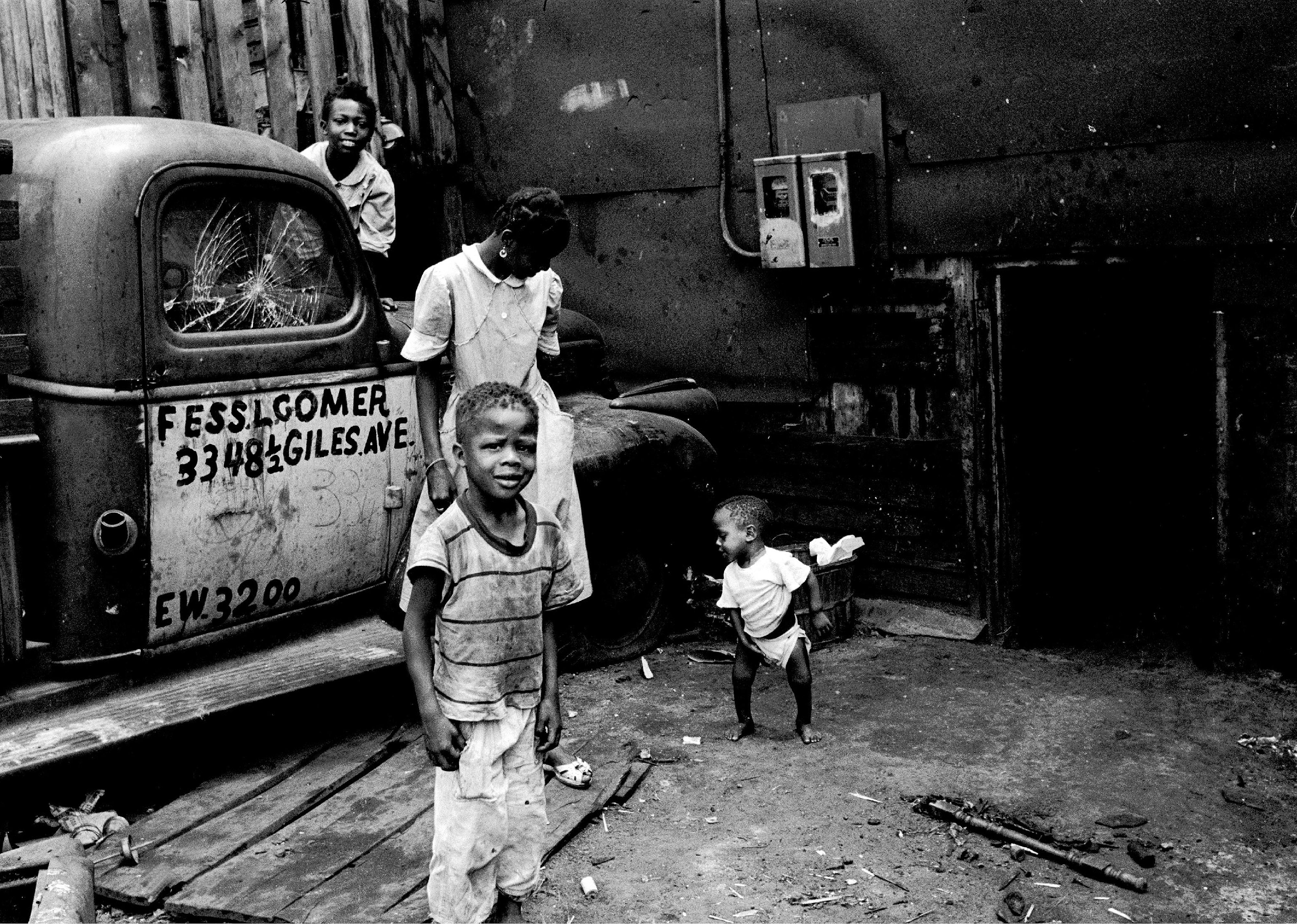 Children play on and around a pickup truck