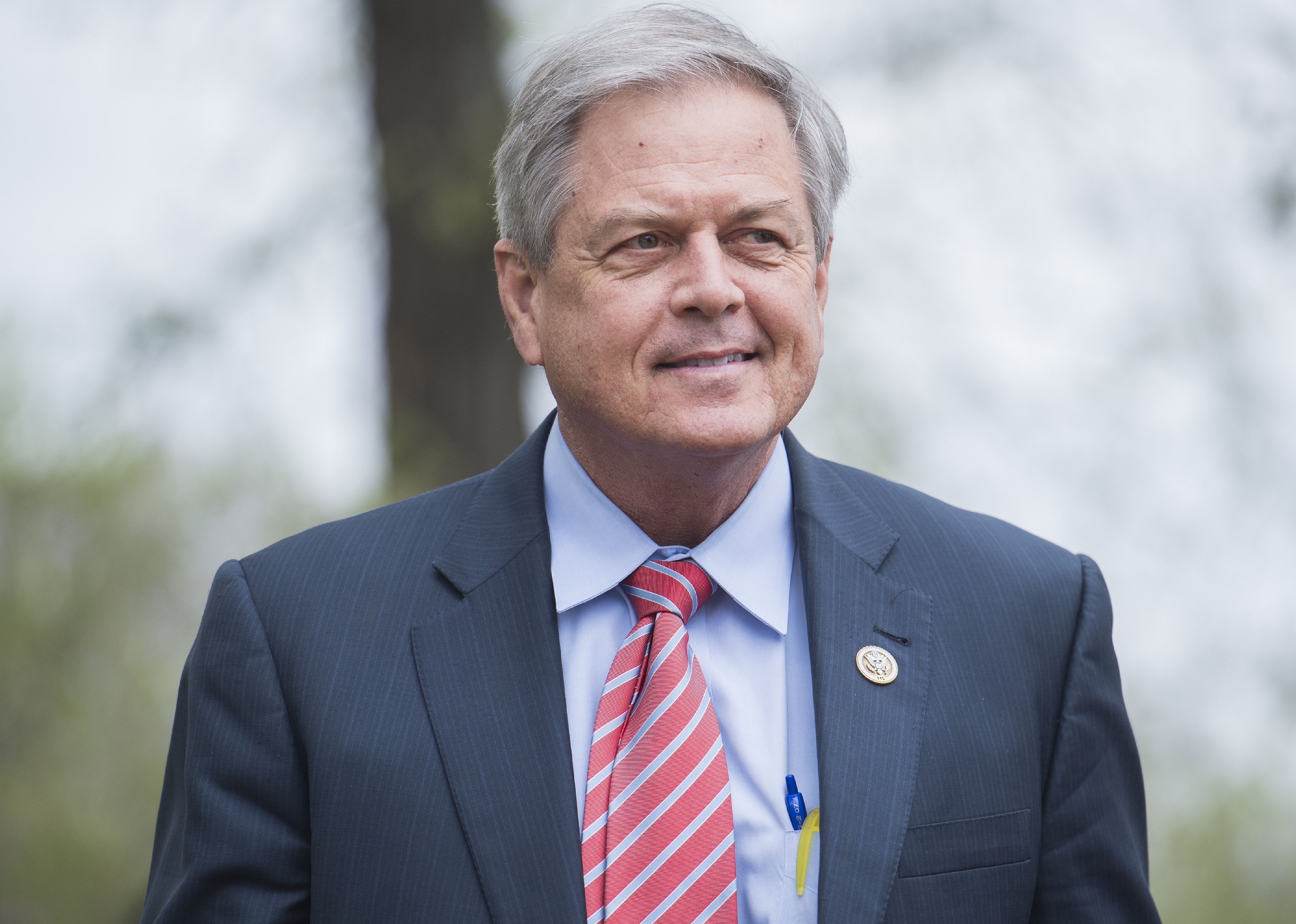 Ralph Norman in a blue suit and red striped tie.