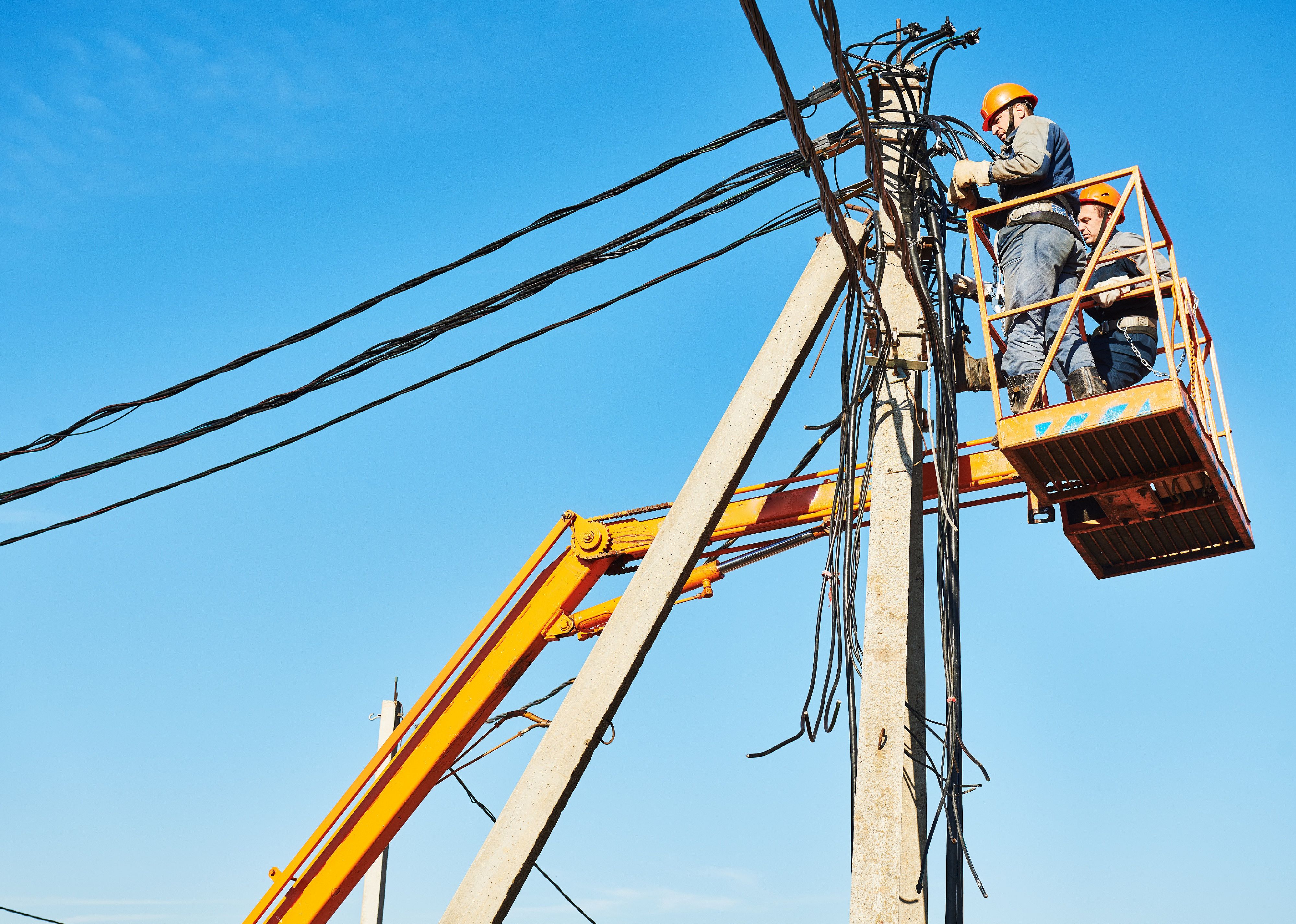 Power lineman at work on a electric pole.